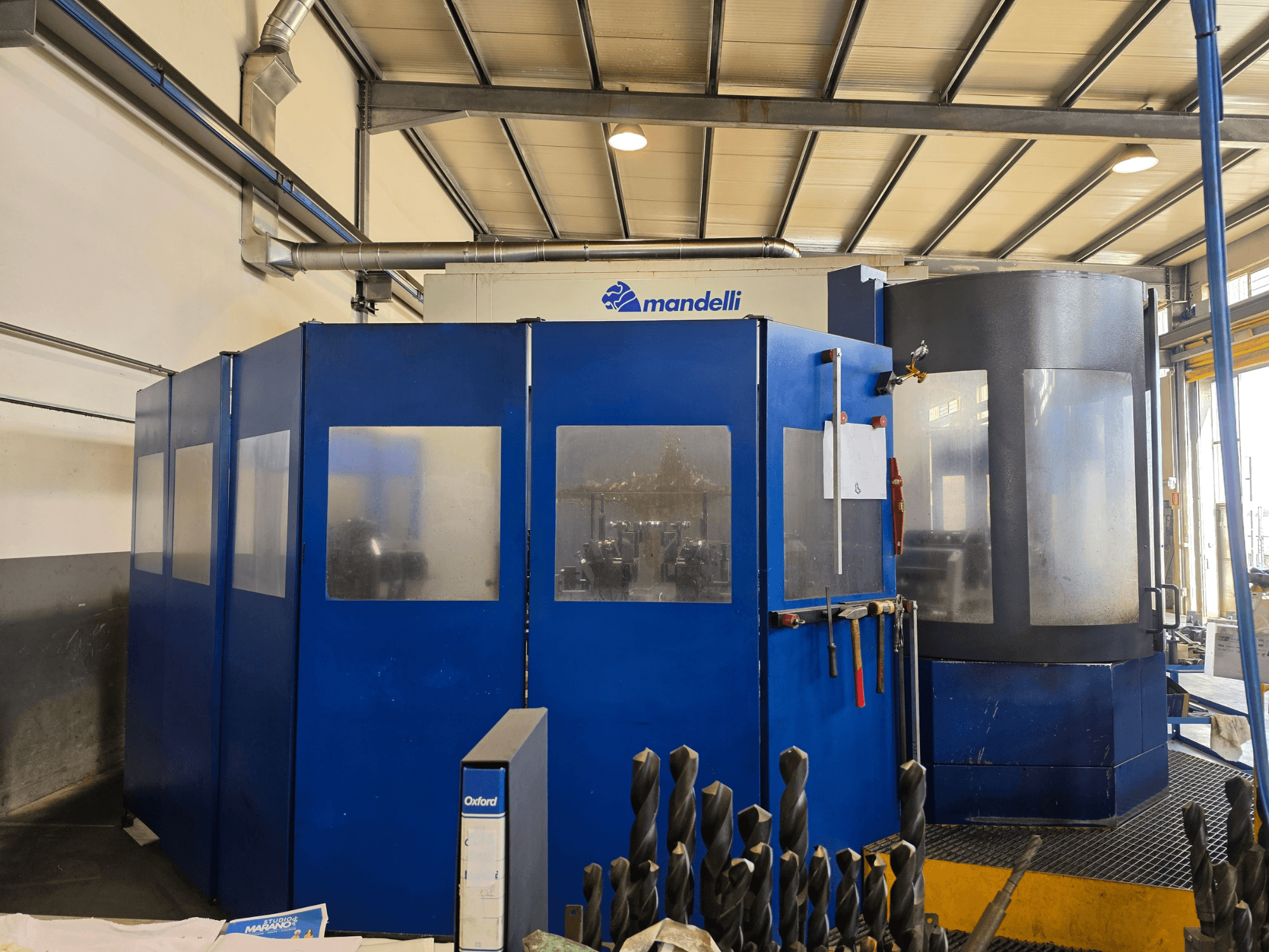 Front view of a Mandelli STORM 1400 Horizontal Machining Centre, featuring blue enclosure and attached tooling.