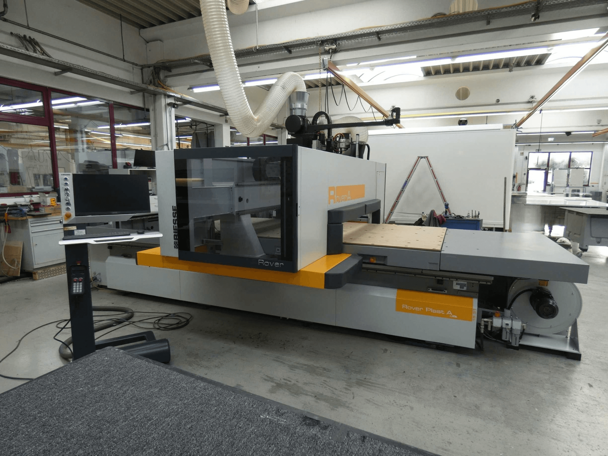 Front view of BIESSE ROVER PLAST A FT 1224 CNC wood machining center with monitor and control panel visible.
