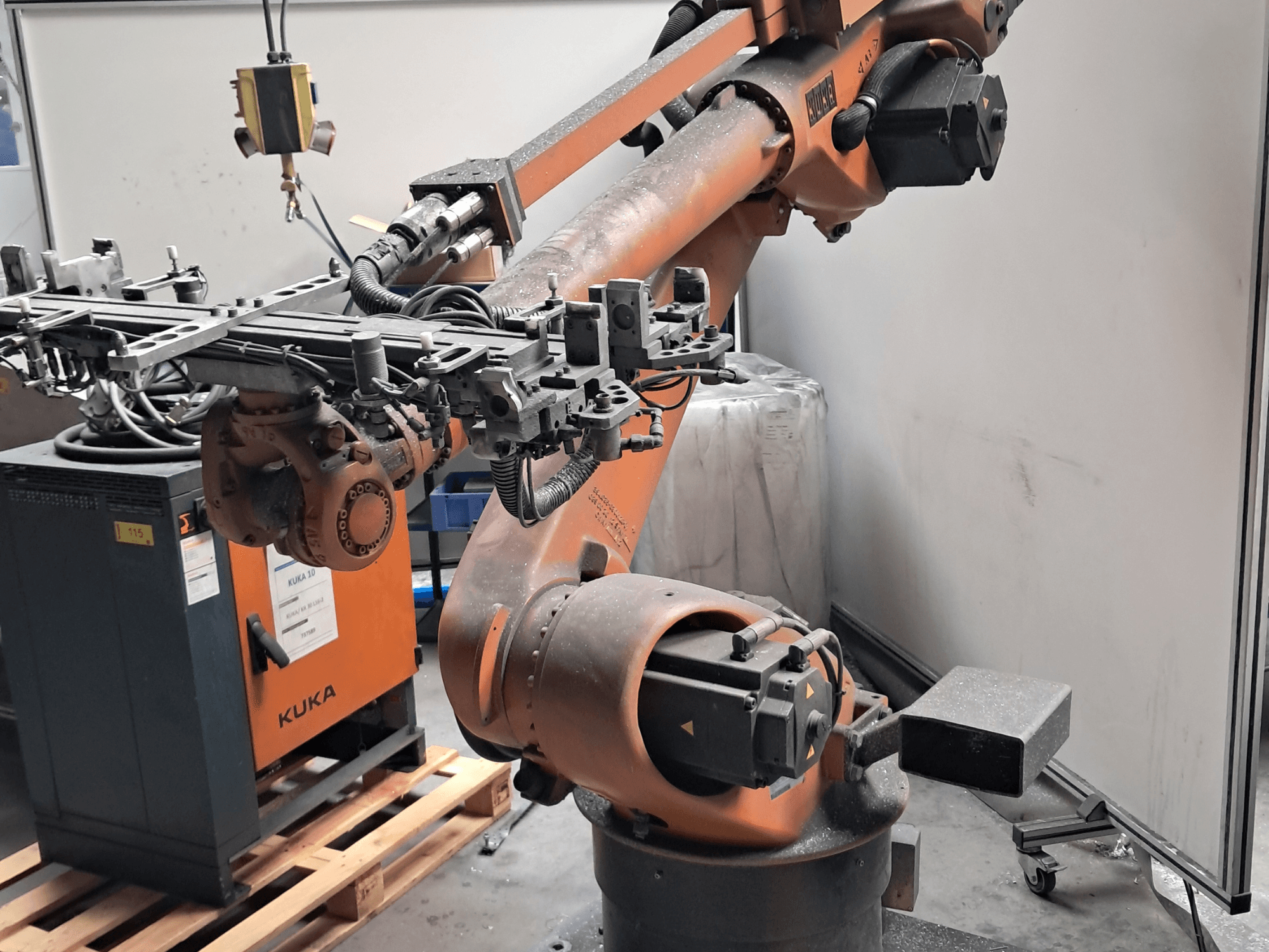 KUKA KR 30L16-2 robot arm in side view, featuring intricate end effector and control cables, set beside a KUKA control box.