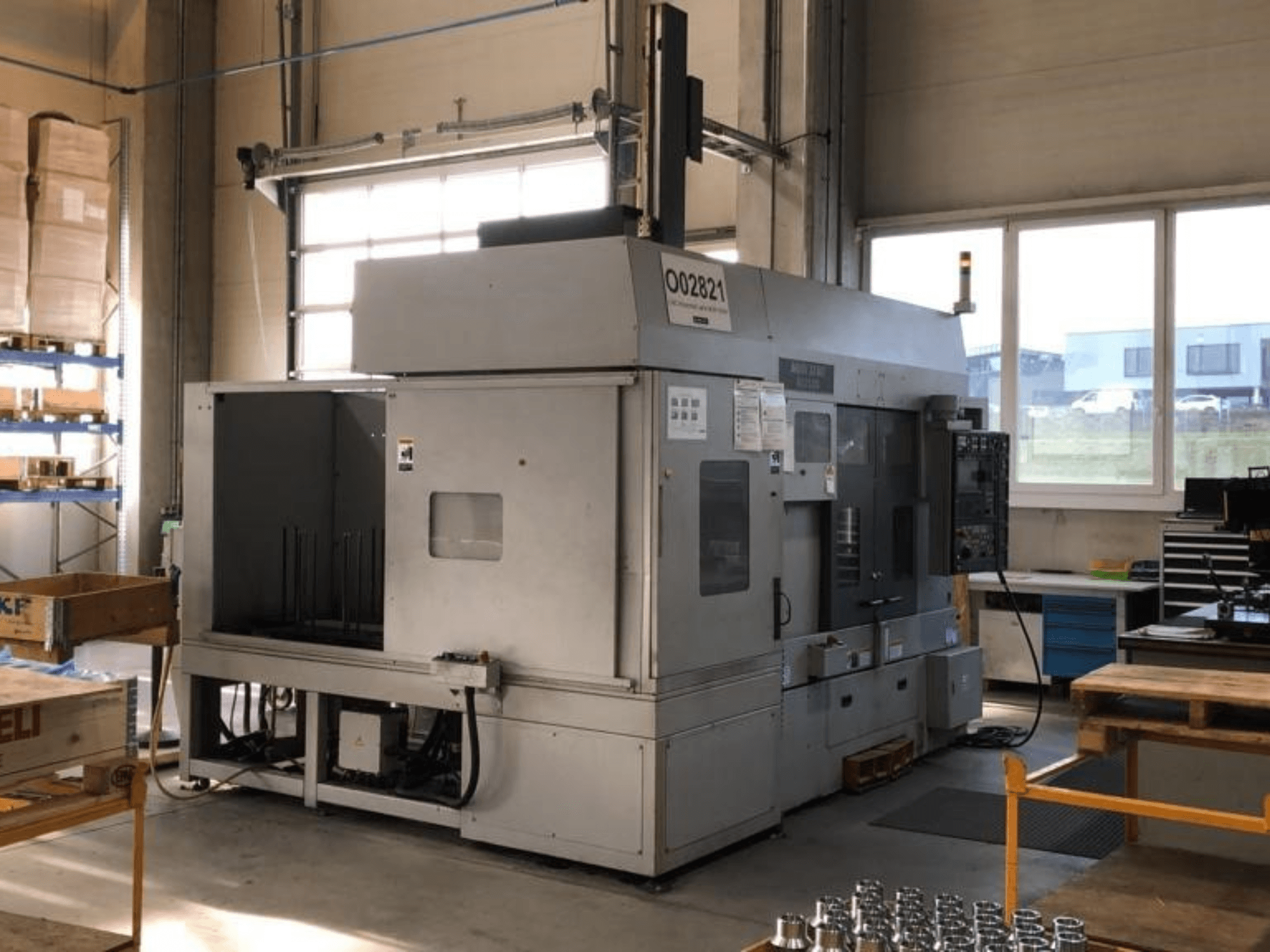 MORI SEIKI RL2500 multi-spindle turning machine in a workshop, showing front view and production area with tools.