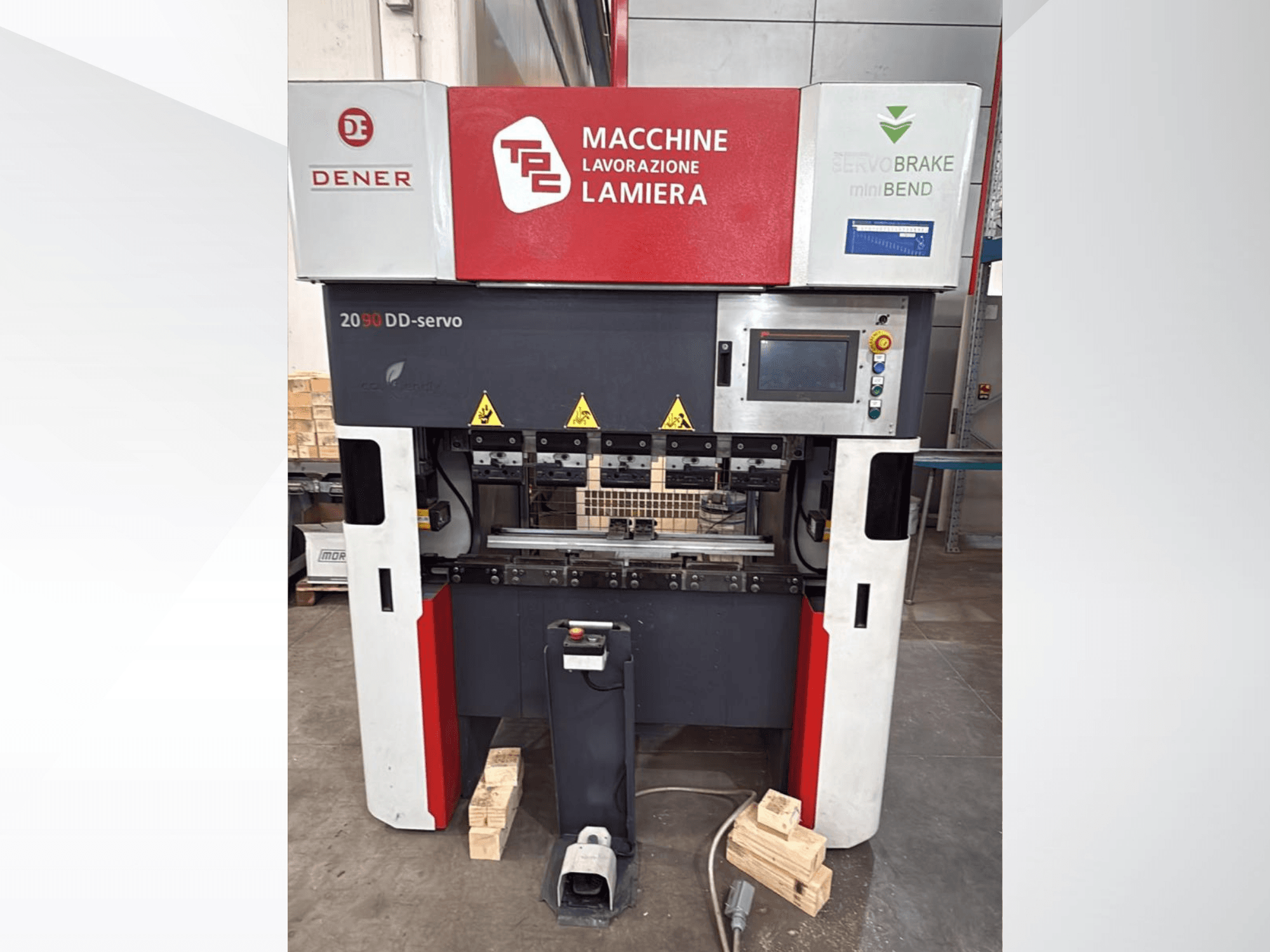 DENER DDS 2090 press brake in front view, featuring control panel, safety labels, and wooden base support.