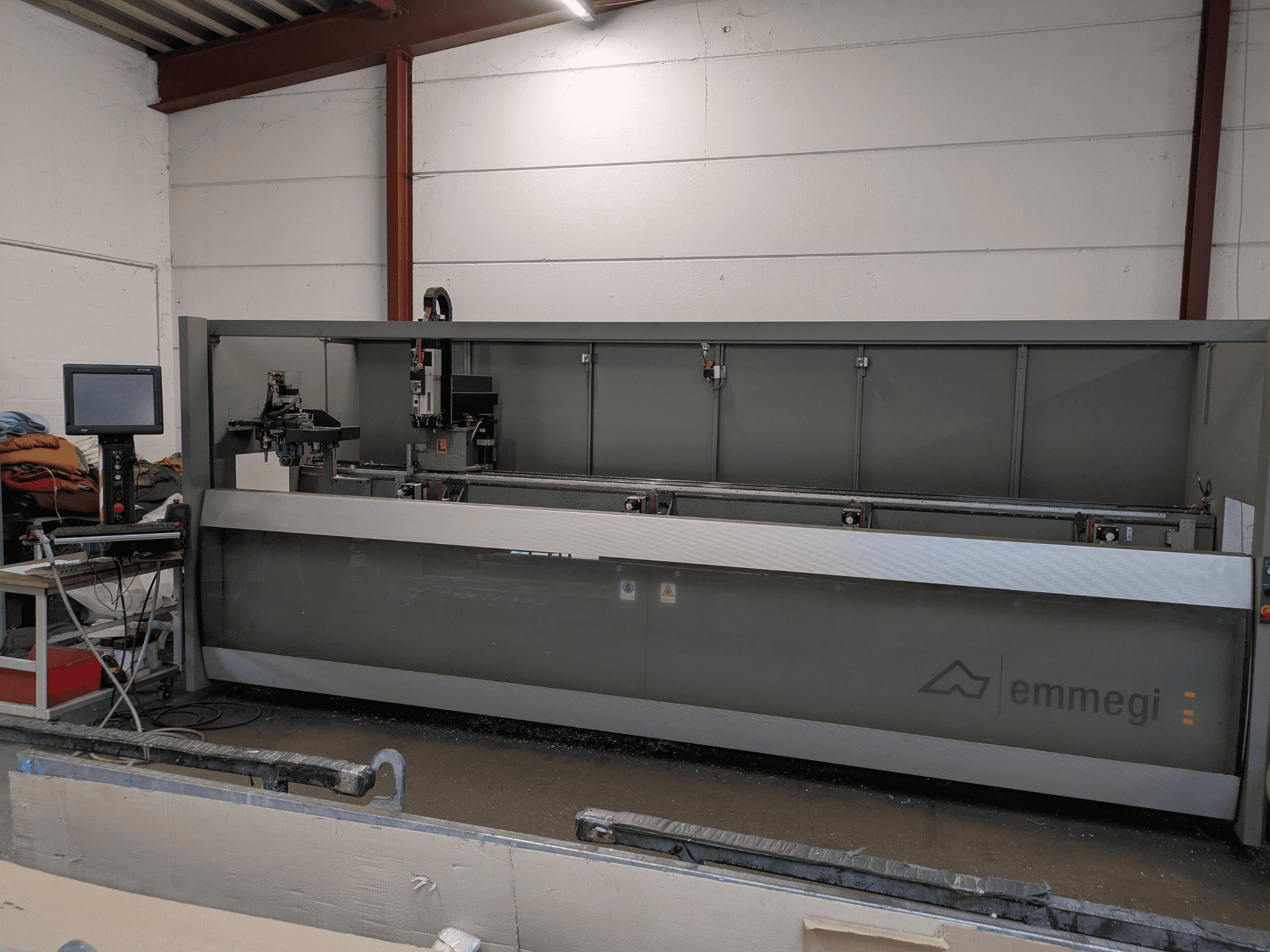 Emmegi Phantomatic T3 vertical machining centre, front view; showcases control panel and cutting area with safety features.