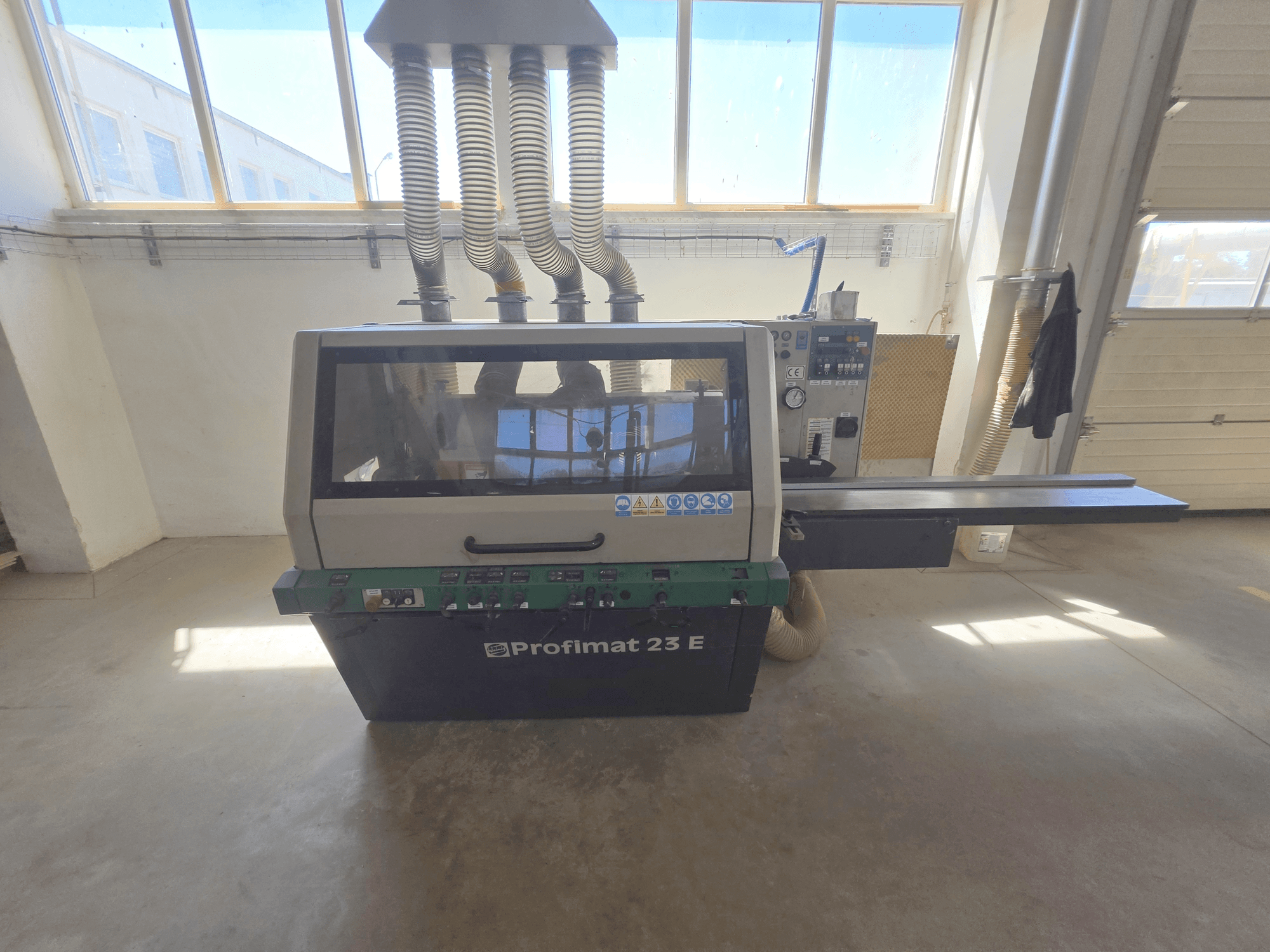 WEINIG DIMTER PROFIMAT 23 E wood planer, front view, features control panel, feed table, and dust extraction hoses.