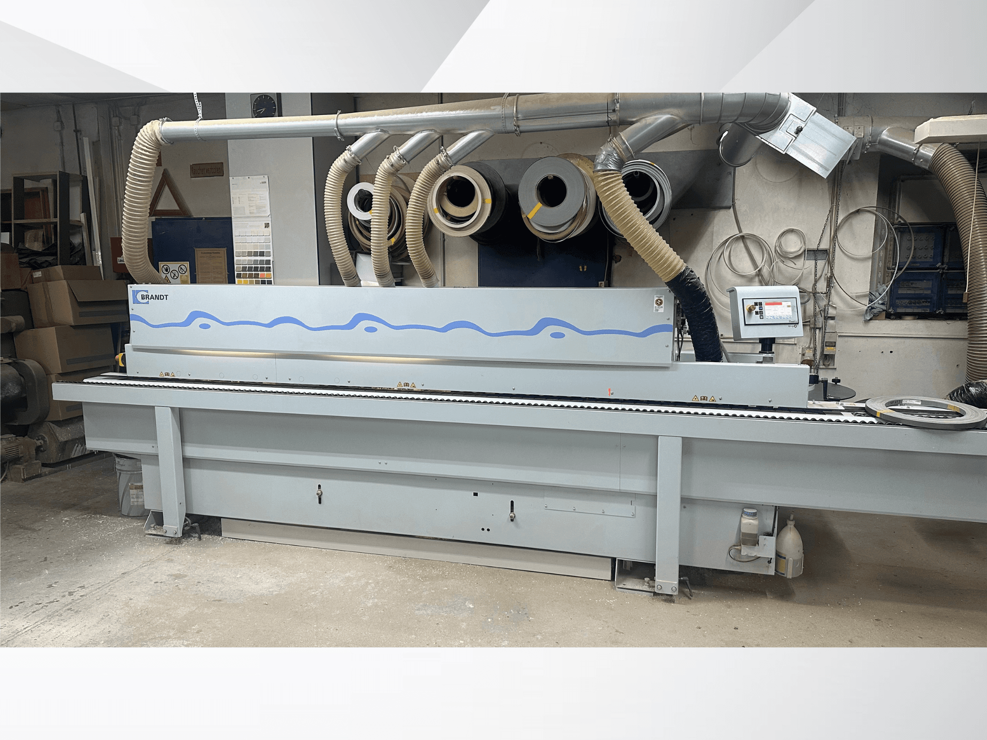 HOMAG KDF 230 edgebander in a workshop, showcasing front view, control panel, and dust extraction system.