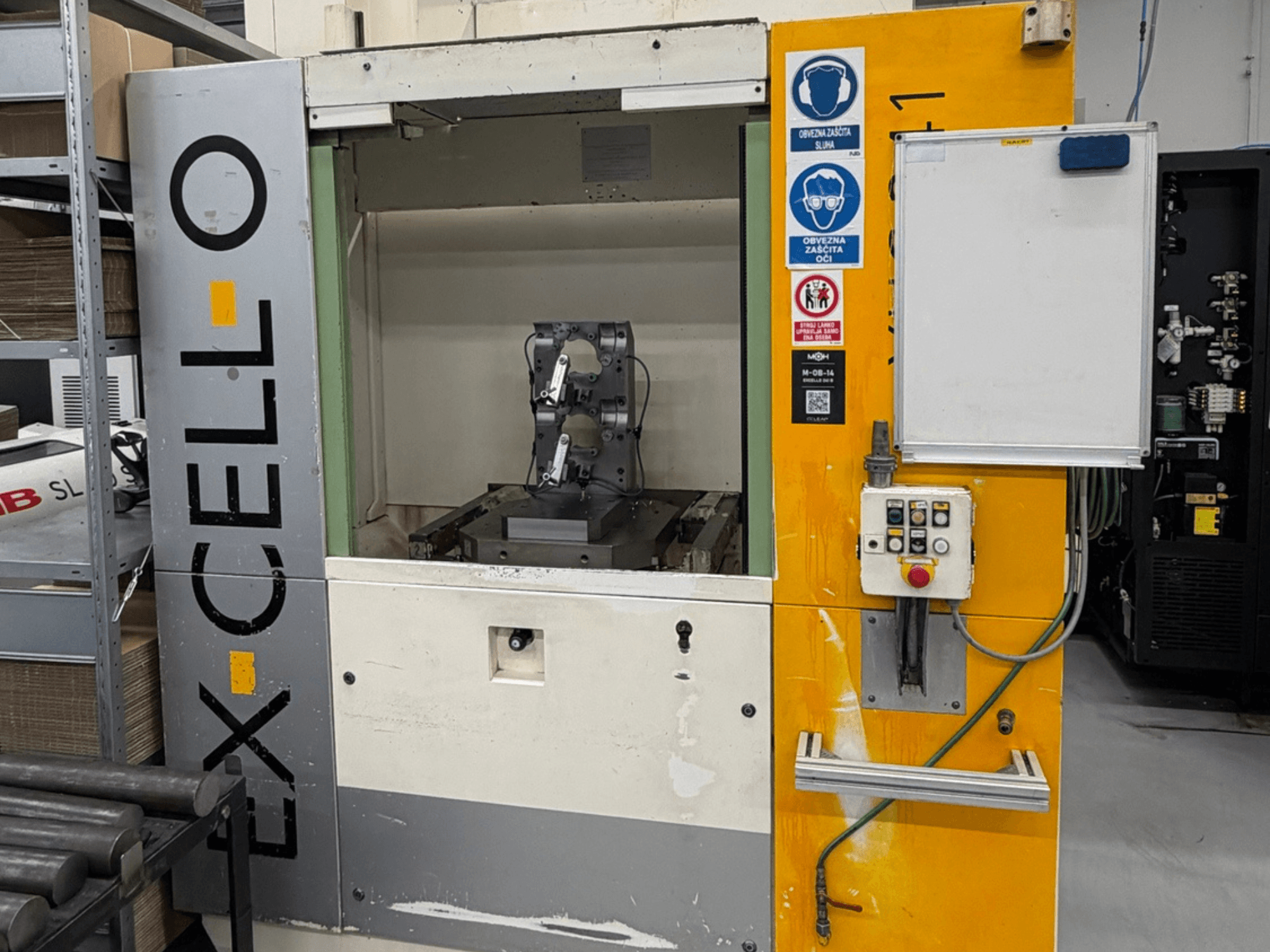 Front view of EXCELLO XHC 241 M/3 Horizontal Machining Centre with visible control panel and machine interior.