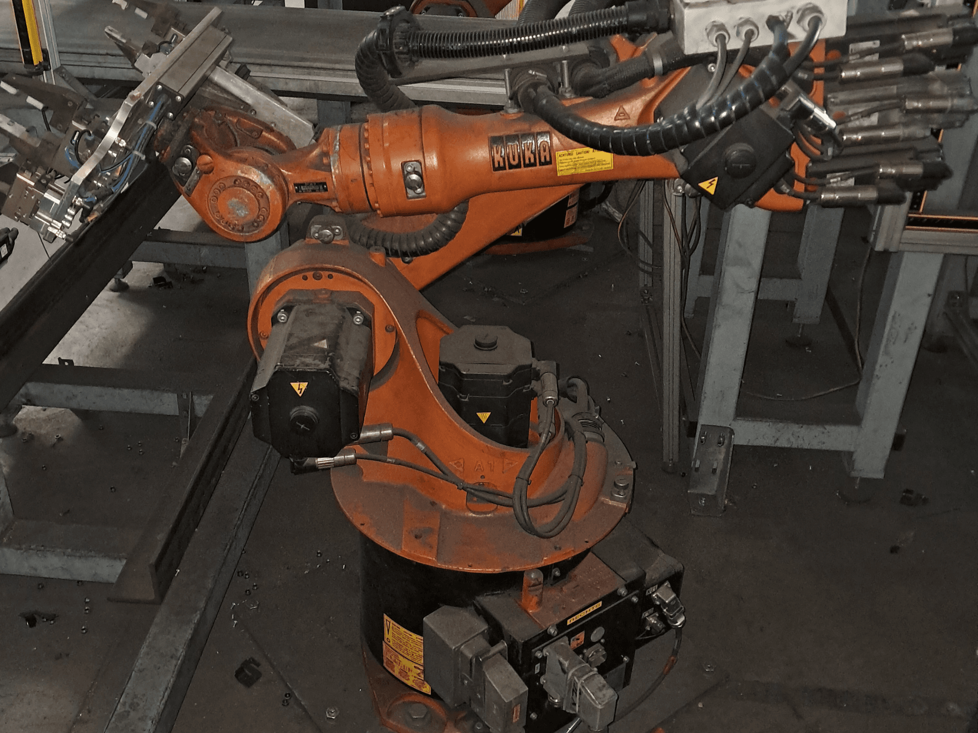KUKA KR 16-2 robot arm in an overhead view, showcasing the orange body, motor, and mechanical components.