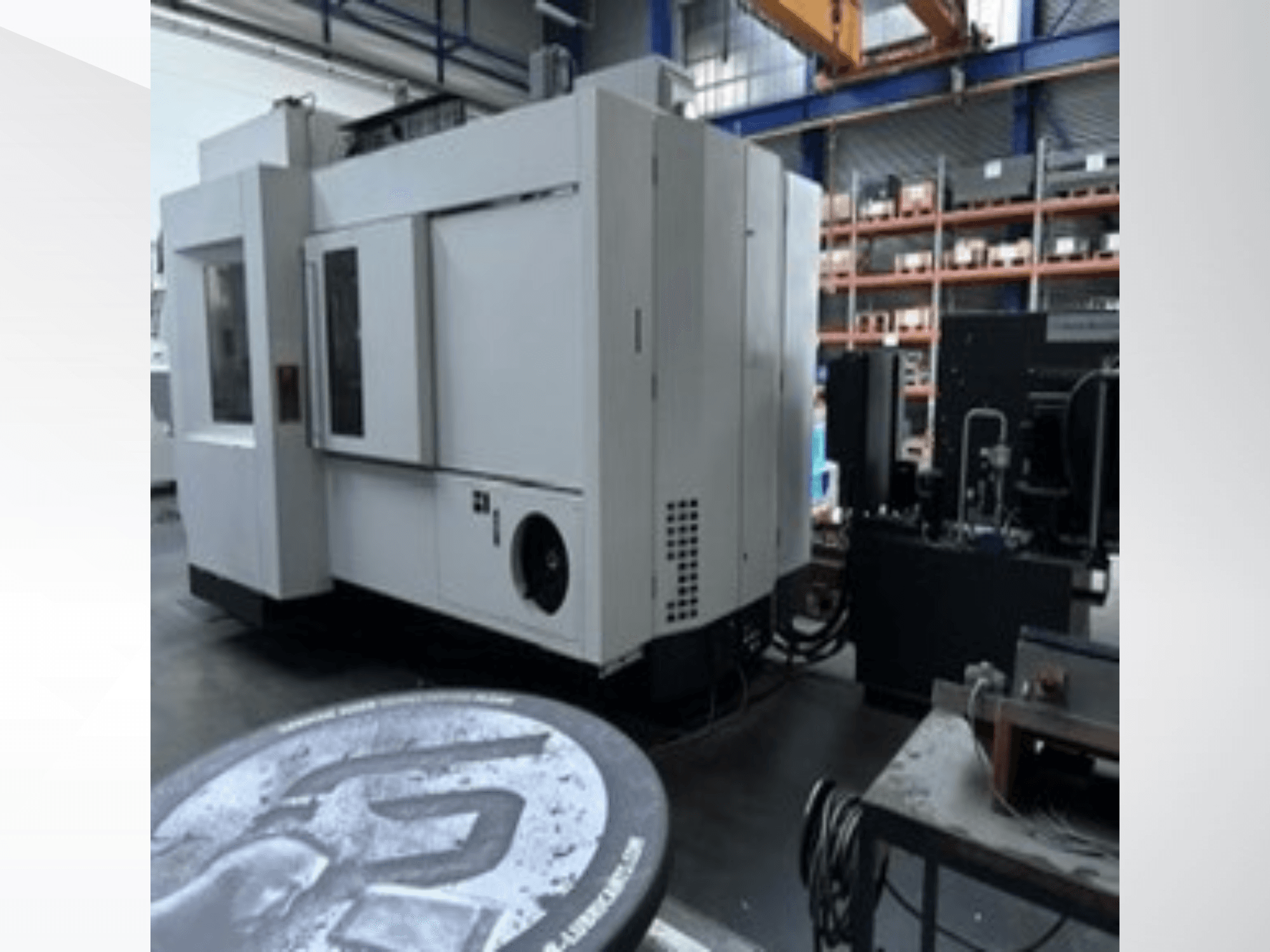 White MIKRON HPM 1350 U Universal Machining Centre in a workshop, side view showing large control panel and industrial setting.