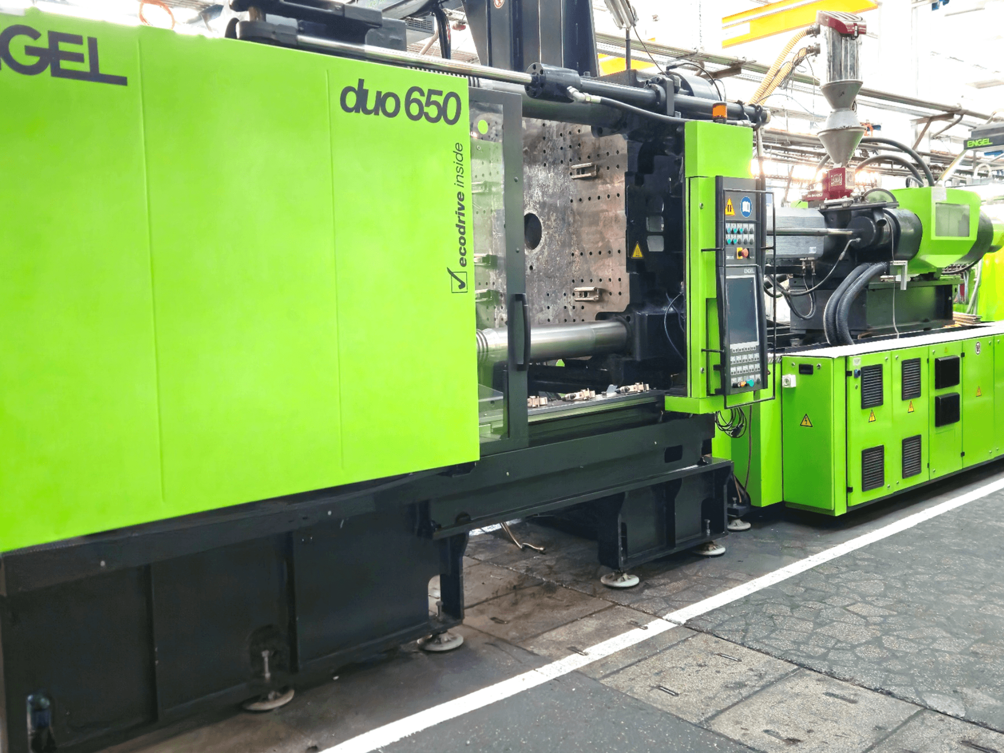 ENGEL duo 650 injection molding machine, front view, bright green color, with control panel and hopper visible.
