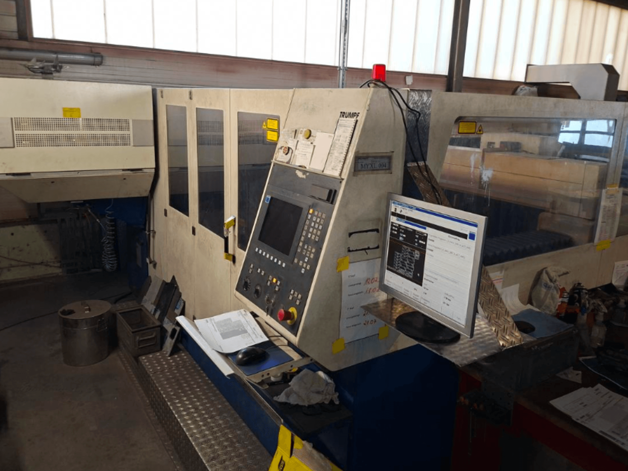 TRUMPF Trumatic L 4030 CO2 Laser Cutting Machine, front view showing control panel and monitor, with workspace details visible.