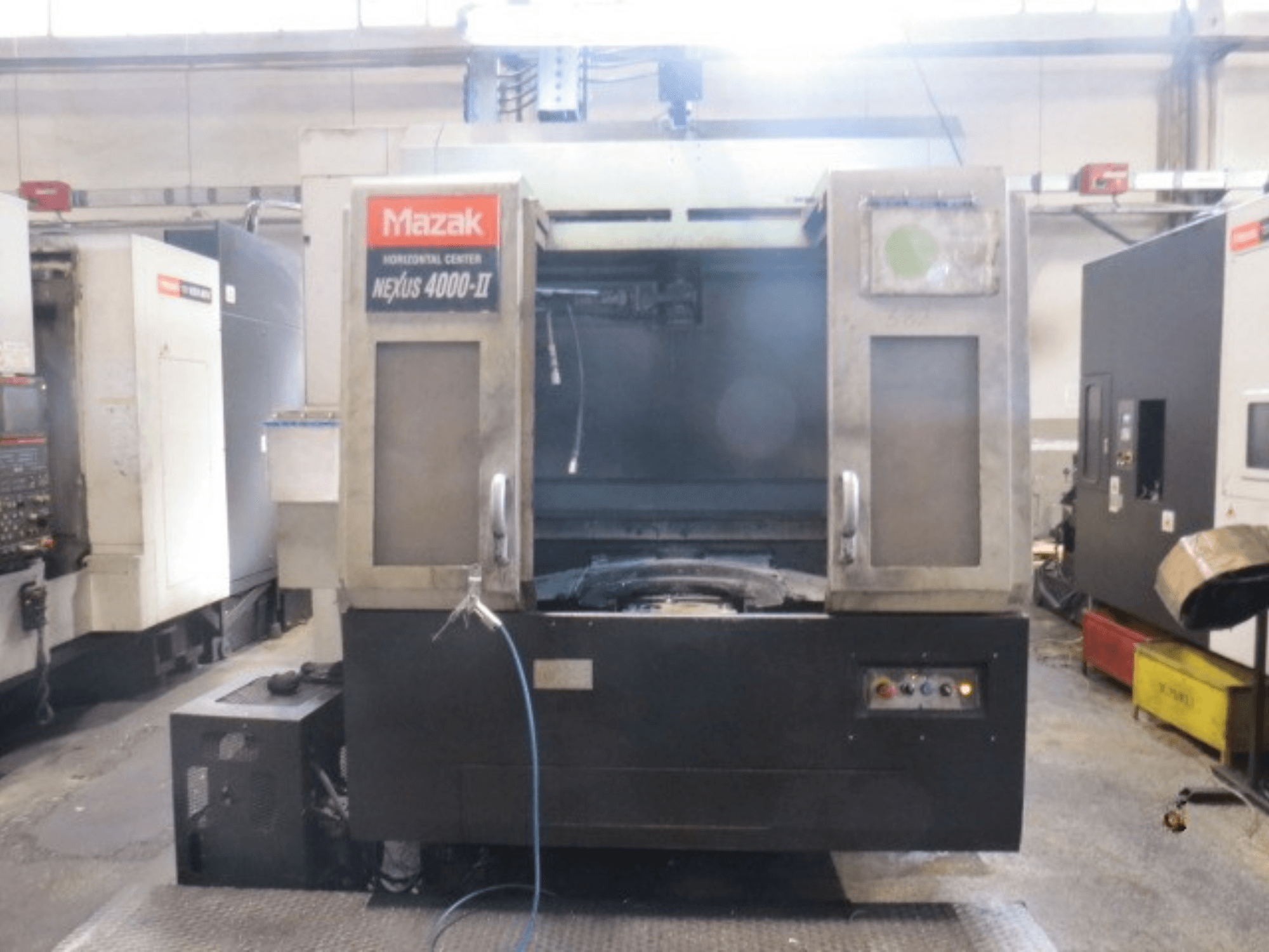 Mazak NEXUS 4000 II horizontal machining center, front view showing control panel, coolant supply, and open work area.