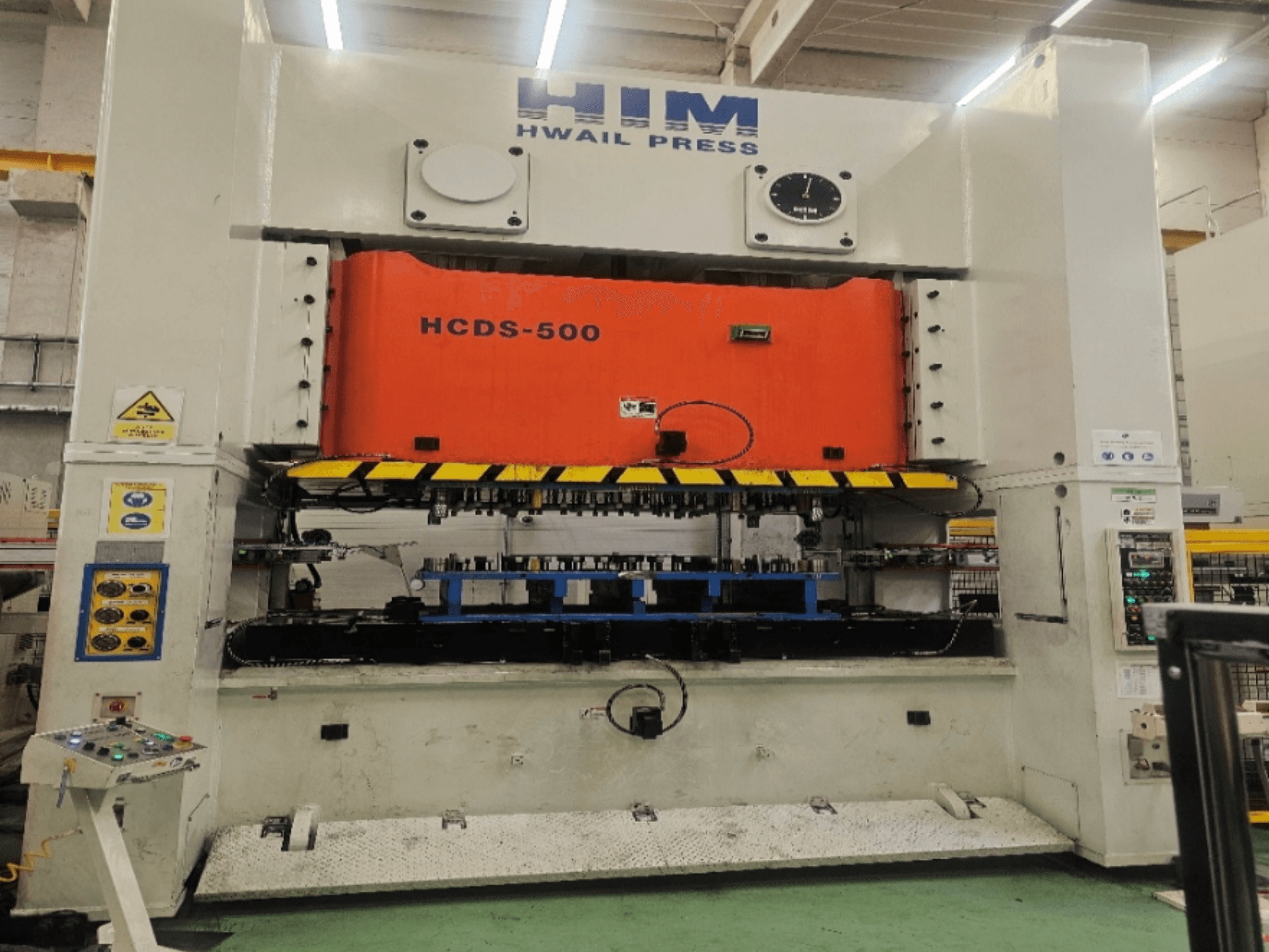 Mechanical stamping press HIM HWAIl PRESS HCDS-500 in front view, featuring an orange pressing plate and control panel.