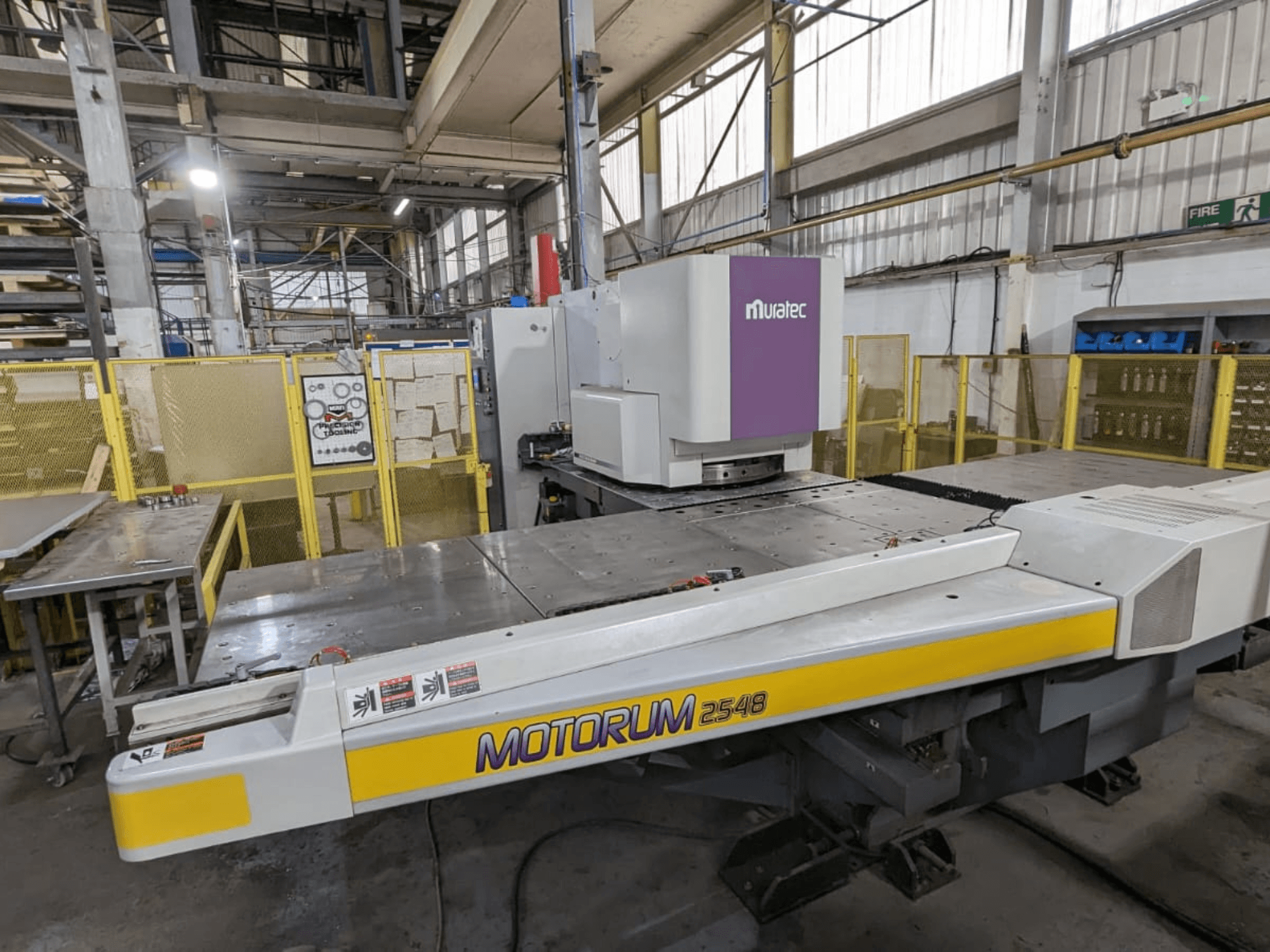 Muratec MOTORUM 2548 CNC punch press, front view showing control panel and work table in a factory setting.