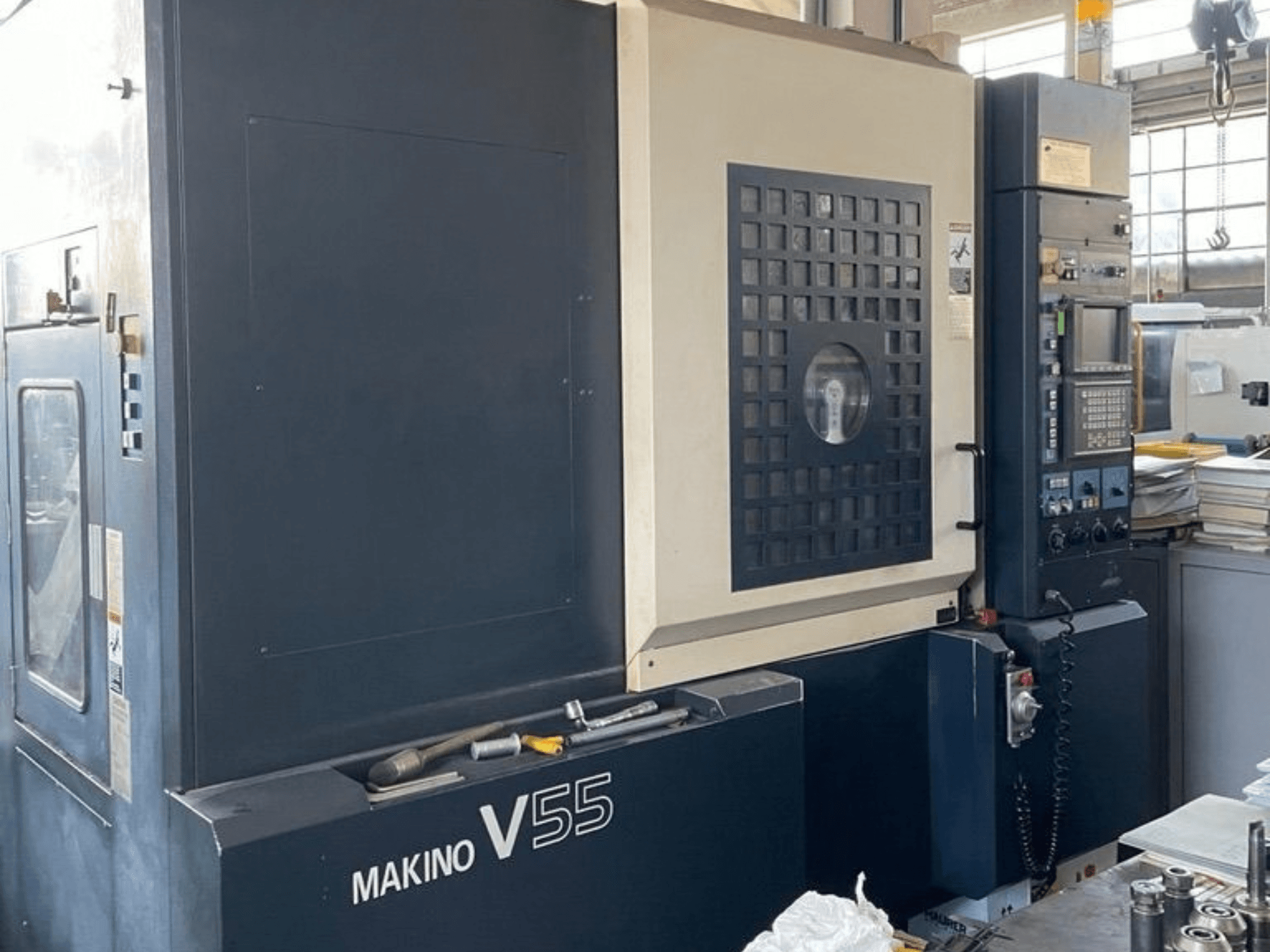 Makino V55-A15 vertical machining center, front view showing control panel, sturdy build, and workspace setup.