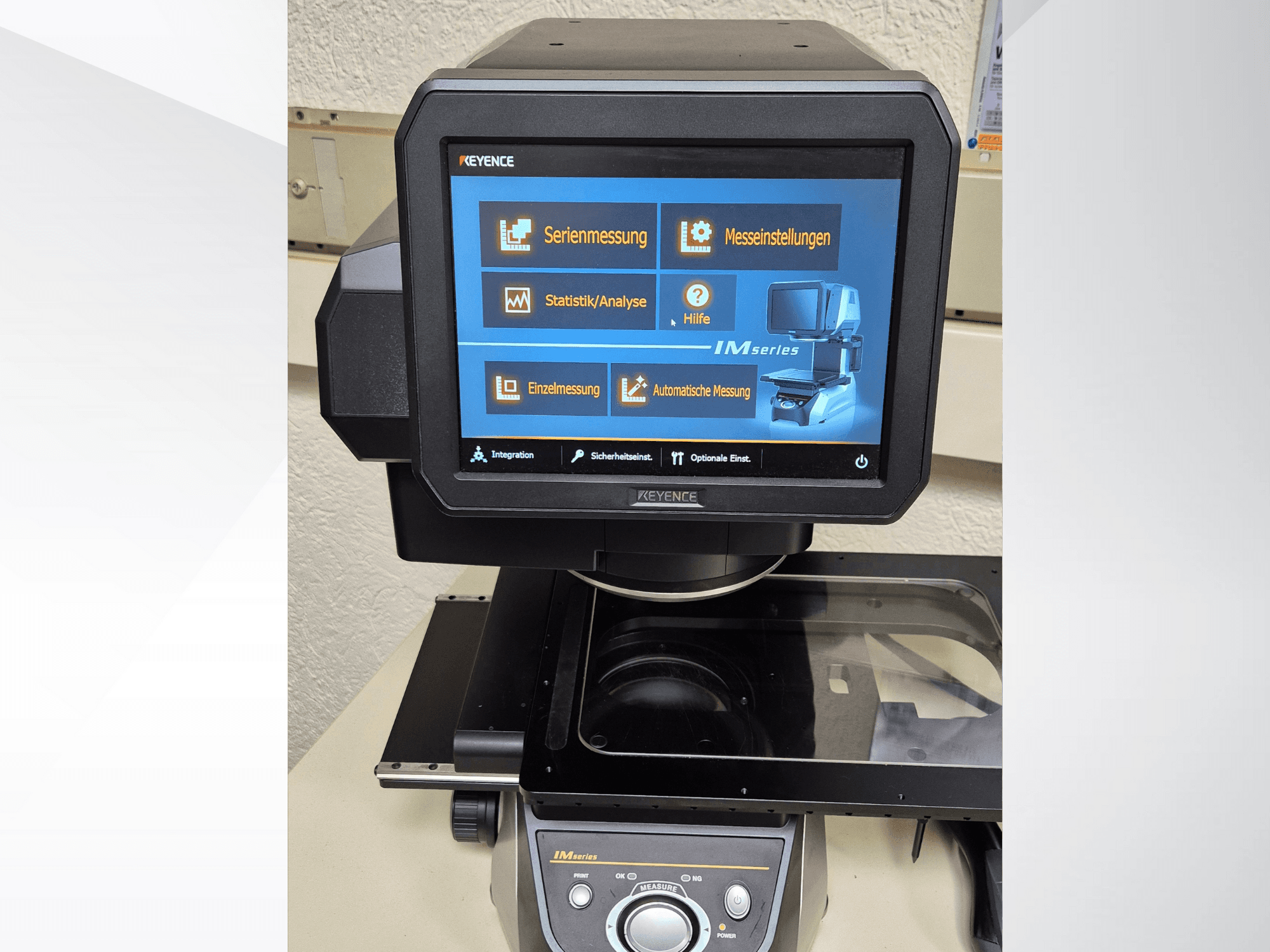 KEYENCE IM series measurement device with a front view touchscreen displaying measurement settings and options.