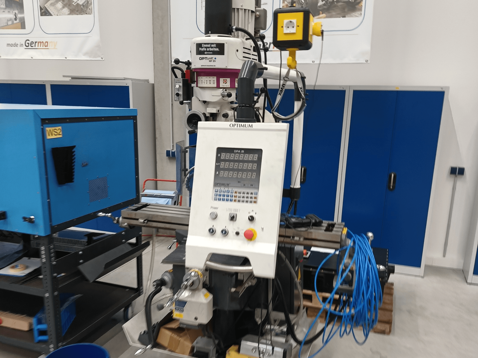 Optimum OPTImill MF 2V vertical machining centre, front view showing control panel, spindle, and blue support cart.