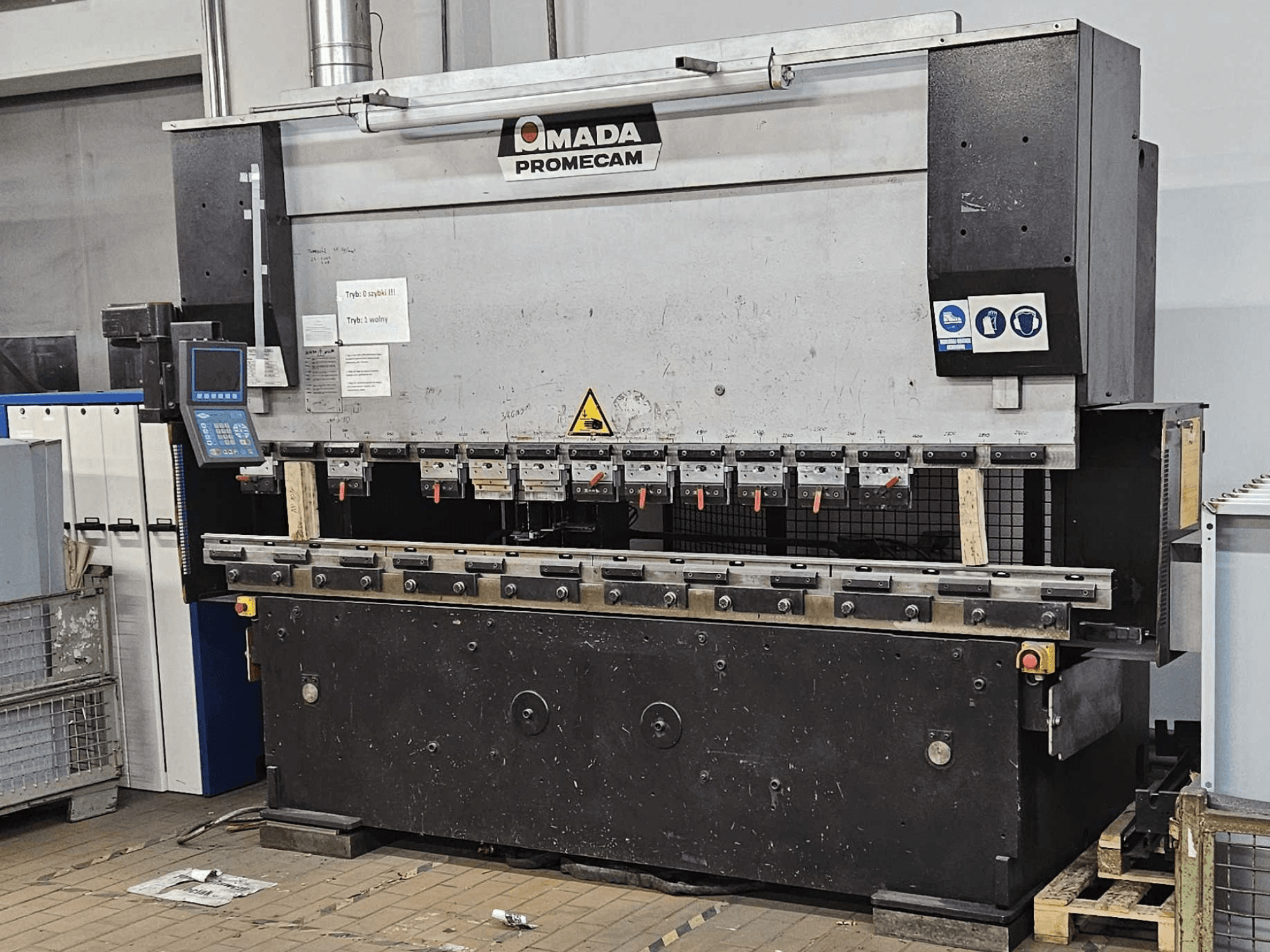 AMADA HFBO 100-30 press brake in front view, featuring digital controls and multiple bending tools on a sturdy base.
