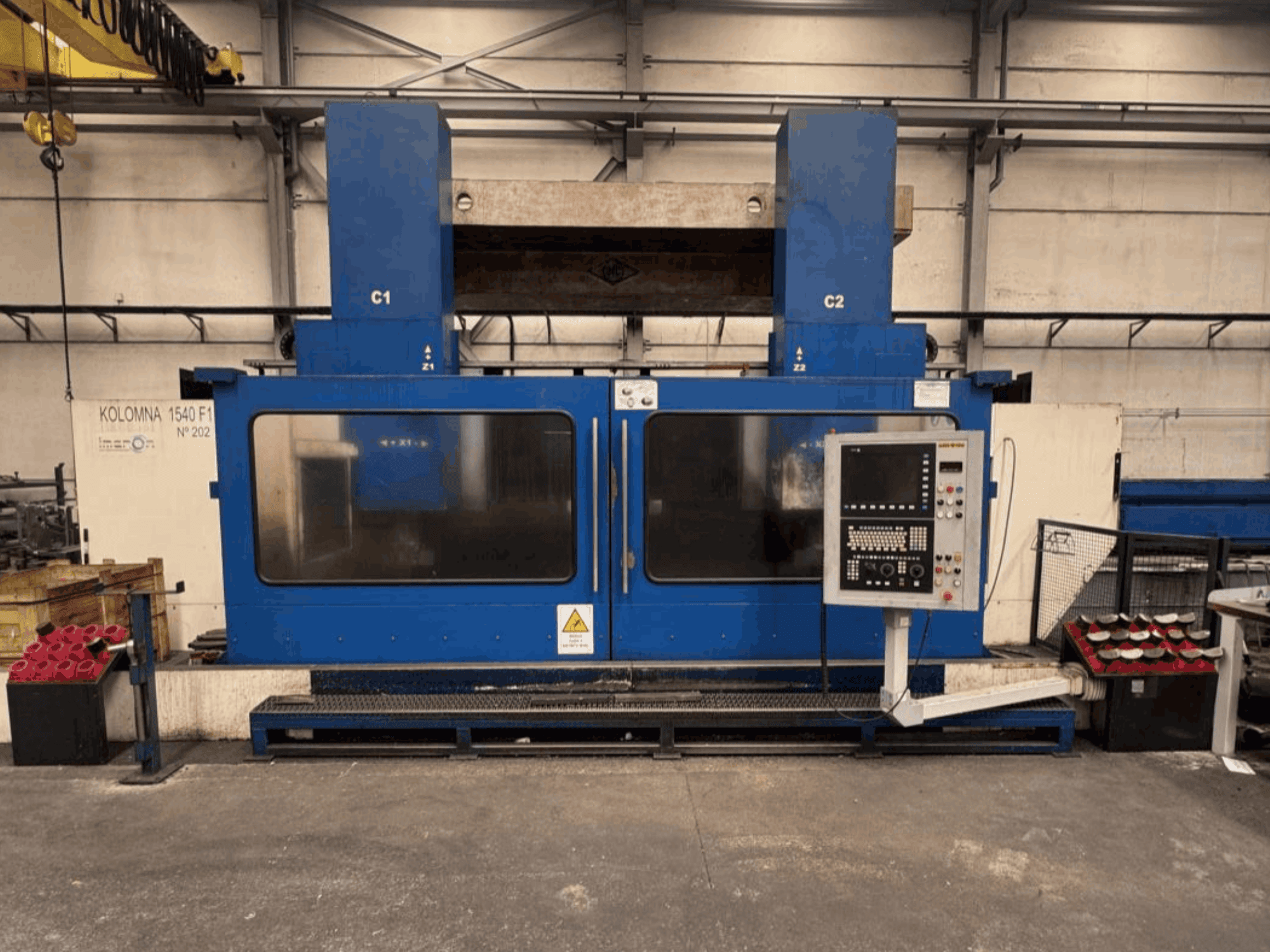 Vertical turning machine KOLOMNA 1540 F1 in blue with control panel, seen from the front, showcasing large work area.