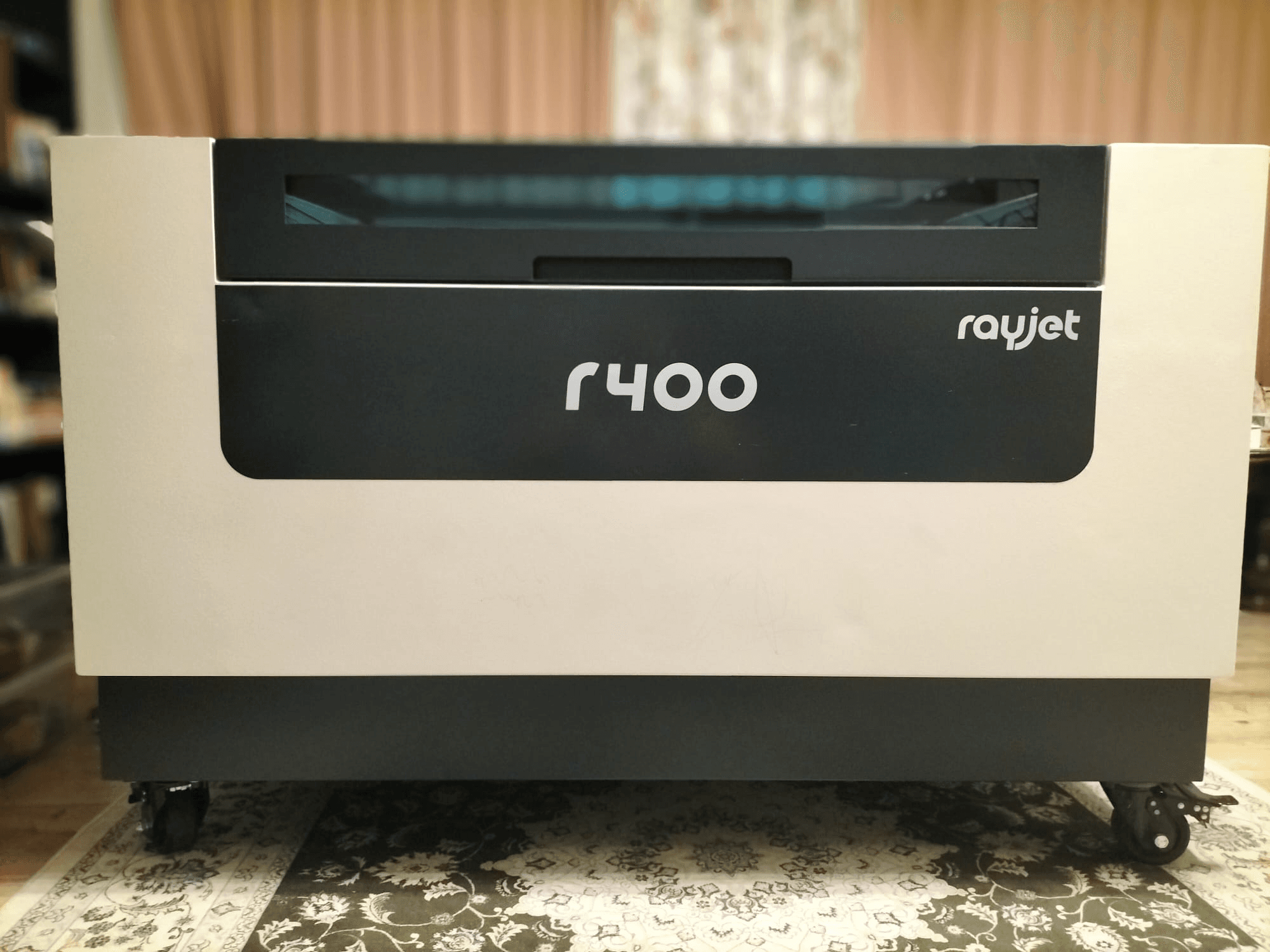 Front view of Trotec Rayjet R400 laser engraving machine, showcasing its sleek design and clear branding.