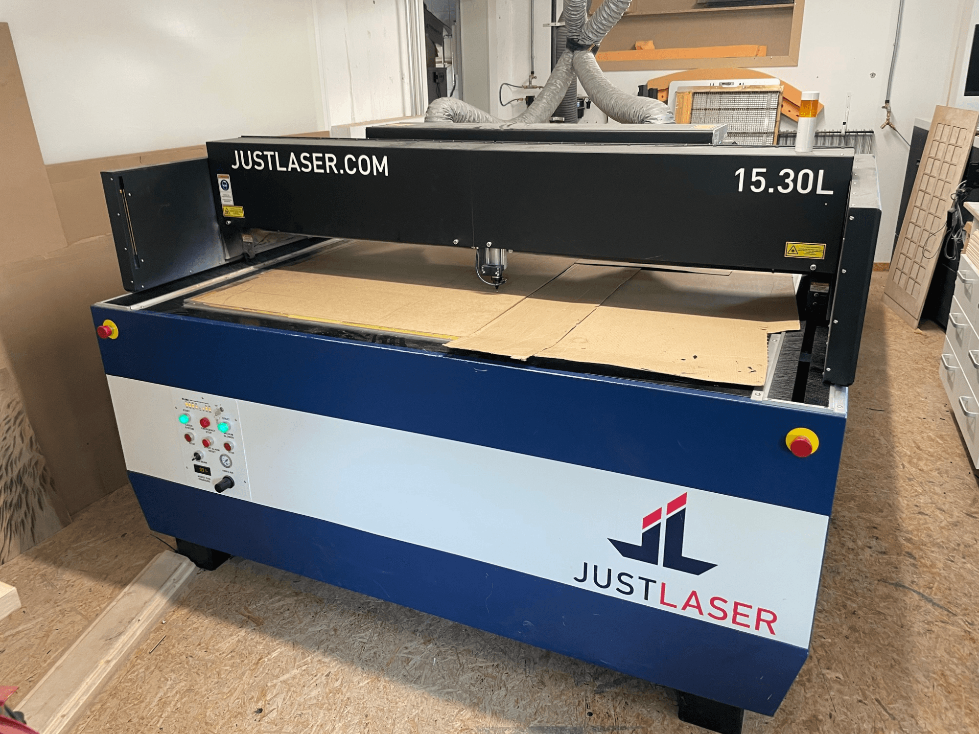 CO2 laser cutting machine by KERN, model KER60120-KT500 OPF, front view showcasing controls and cutting area with cardboard.