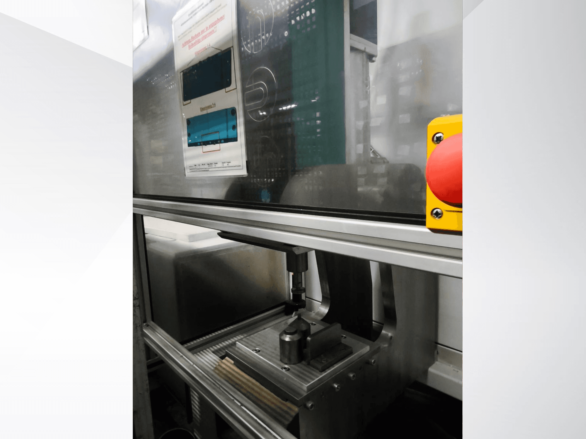 Front view of EMS Automation Buchsenpresse machine tool, showcasing the pressing mechanism and safety button.