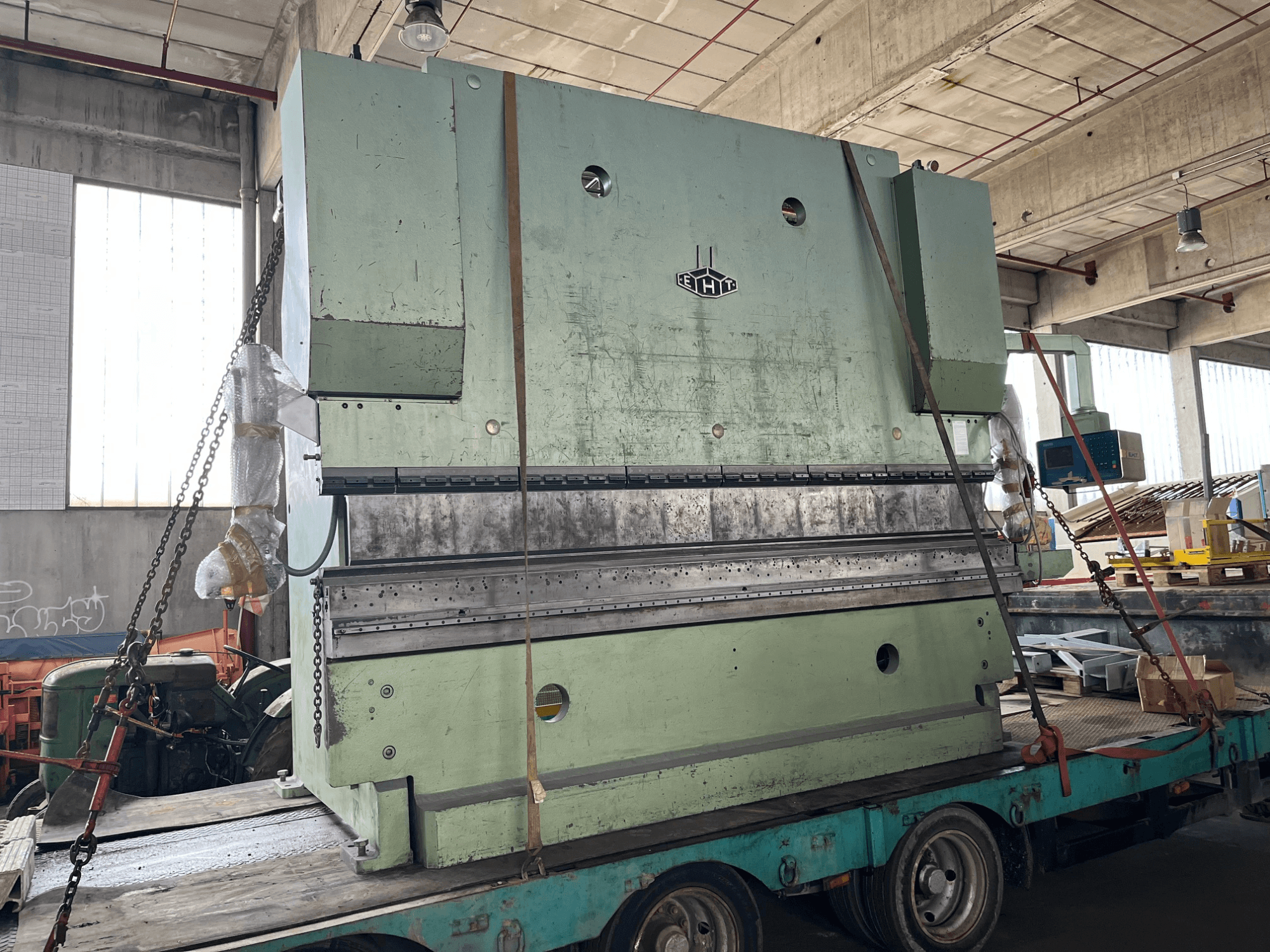 EHT EHPS 20-35 press brake viewed from the side, showcasing the large green structure and control panel on a trailer.