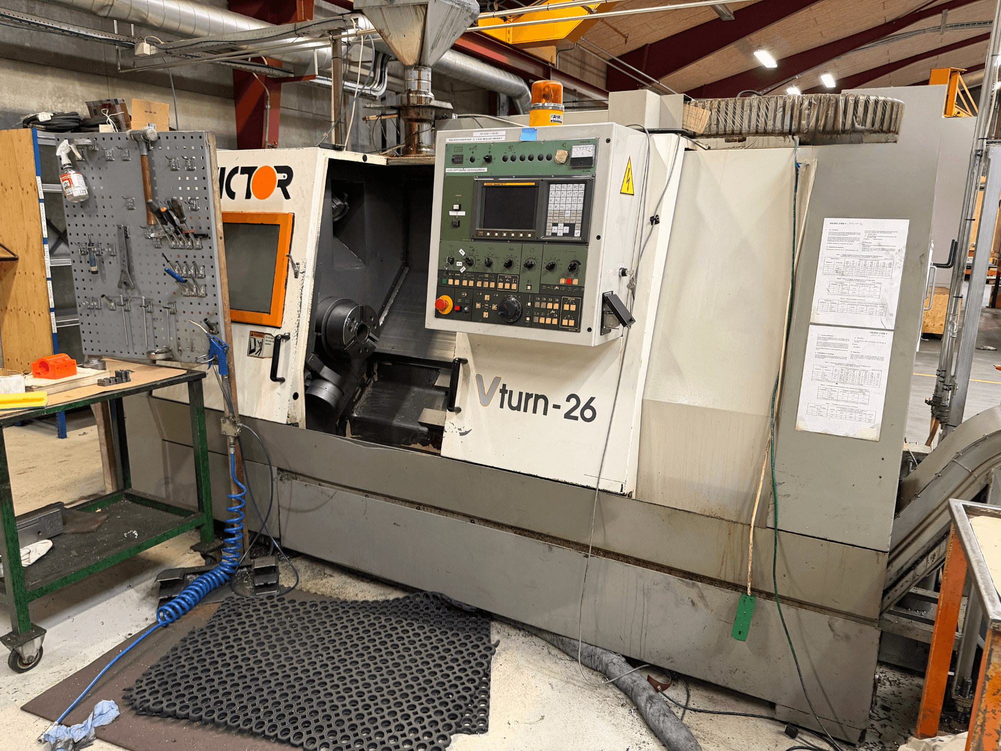 Victor VTurn-26 horizontal turning machine, front view, showcases control panel and operational components in workshop setting.