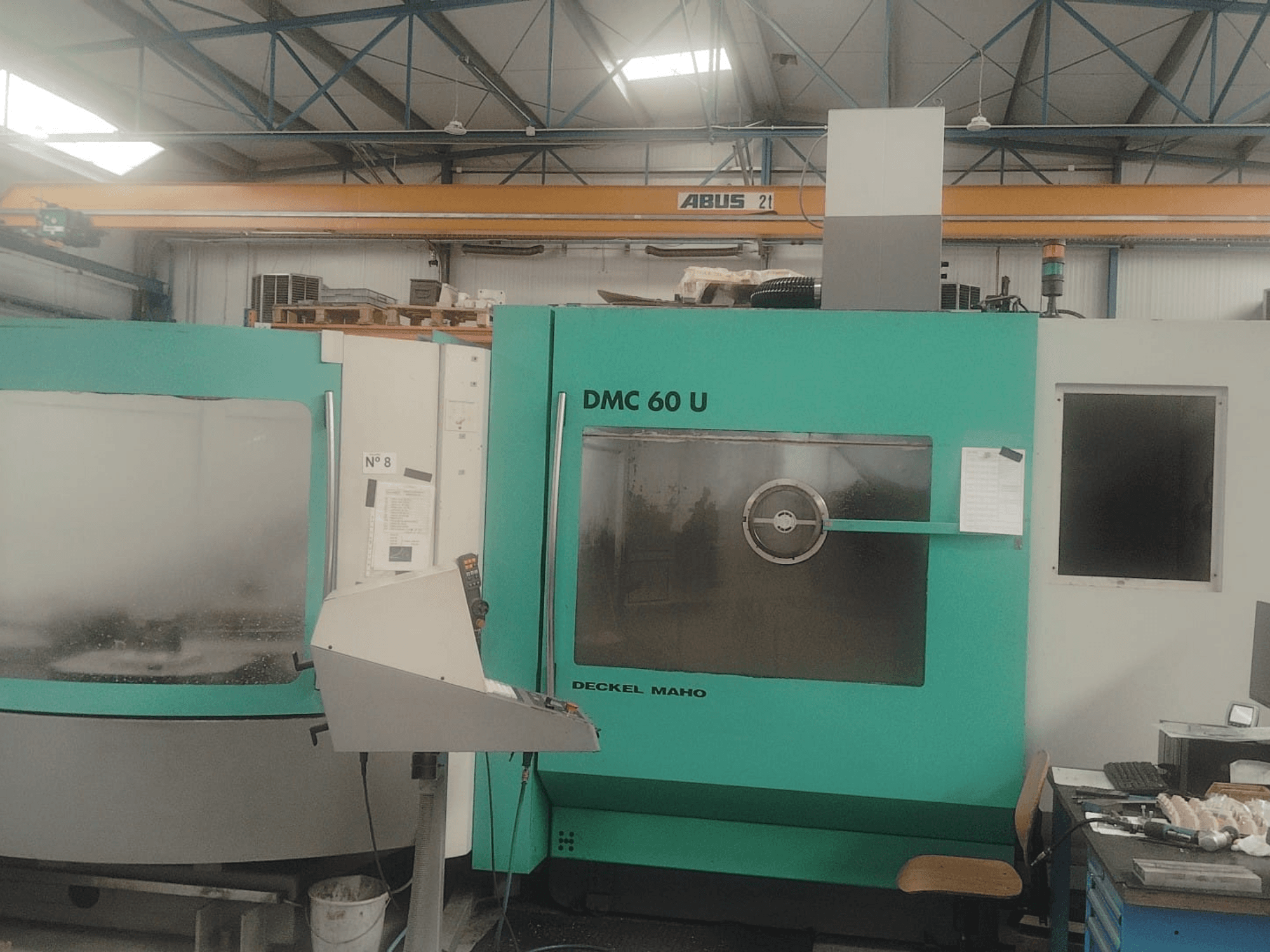 Front view of a DECKEL MAHO DMC 60 U Mill-Turn Centre, featuring a control panel and large glass viewing window.