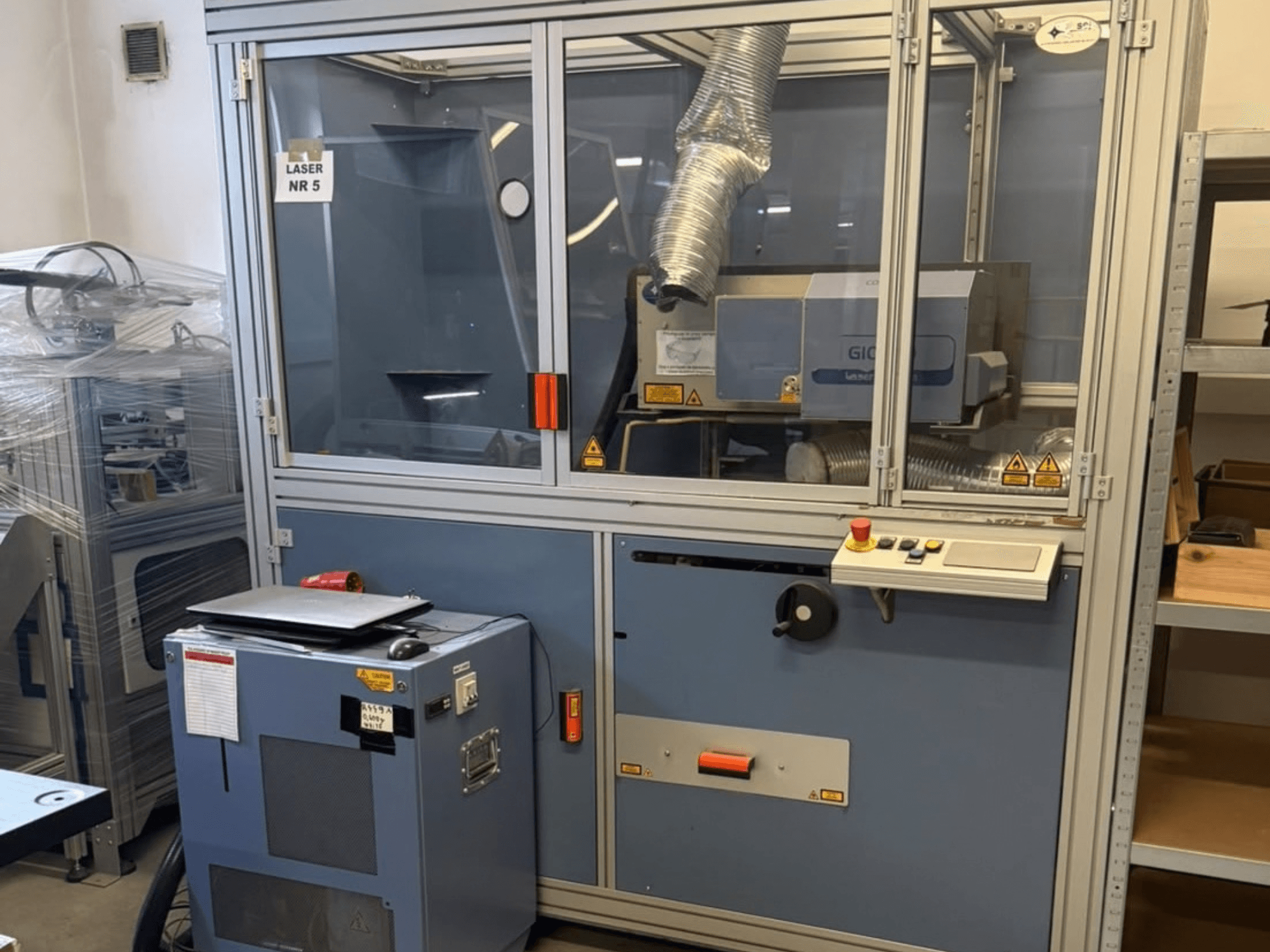 CO2 Laser Cutting Machine SEI Laser PAPER BLASTER 02, front view, features control panel and exhaust duct.