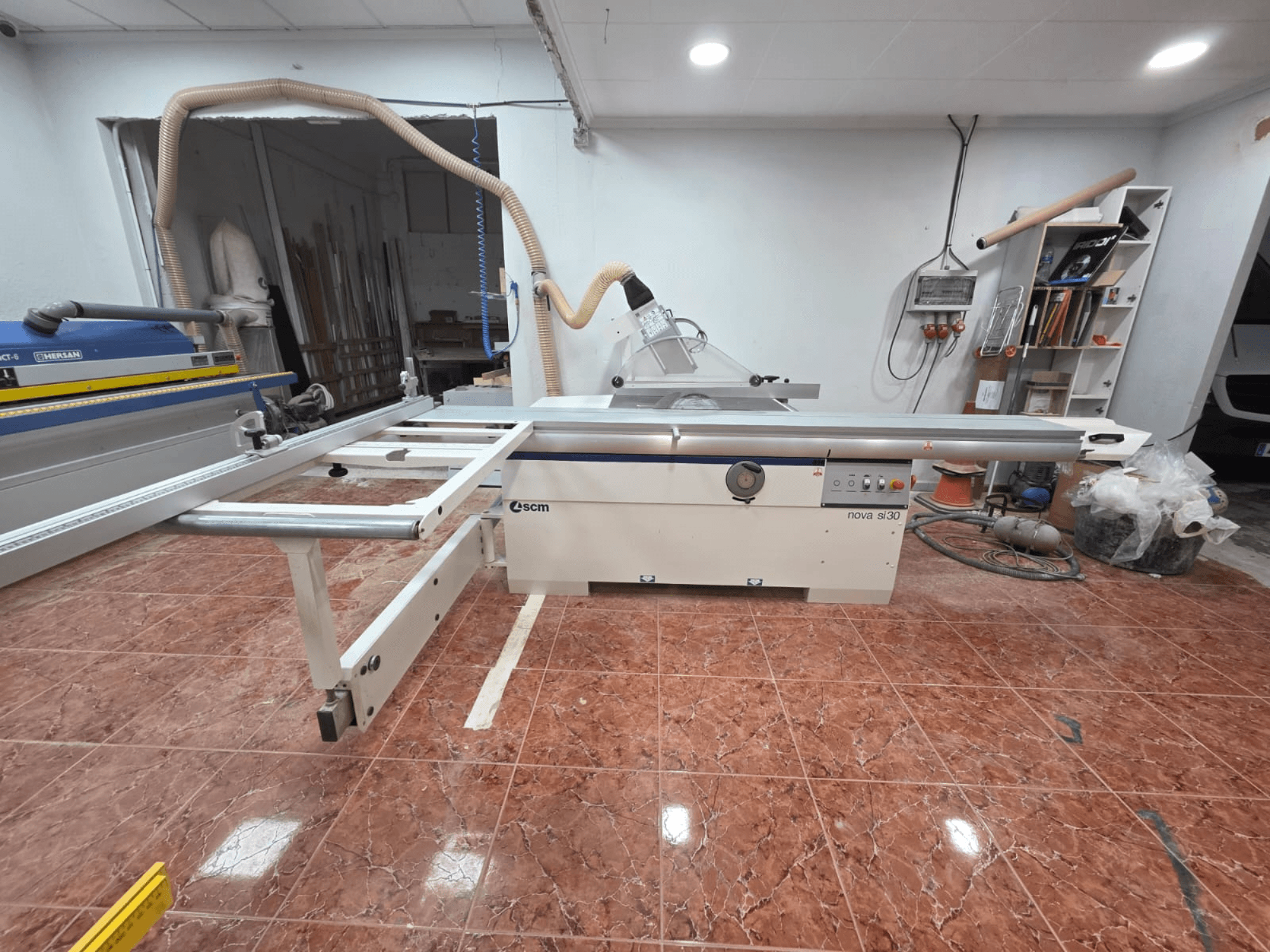 SCM NOVA SI 30 panel saw in a workshop, viewed from the front, showcasing the cutting table and controls on the chassis.