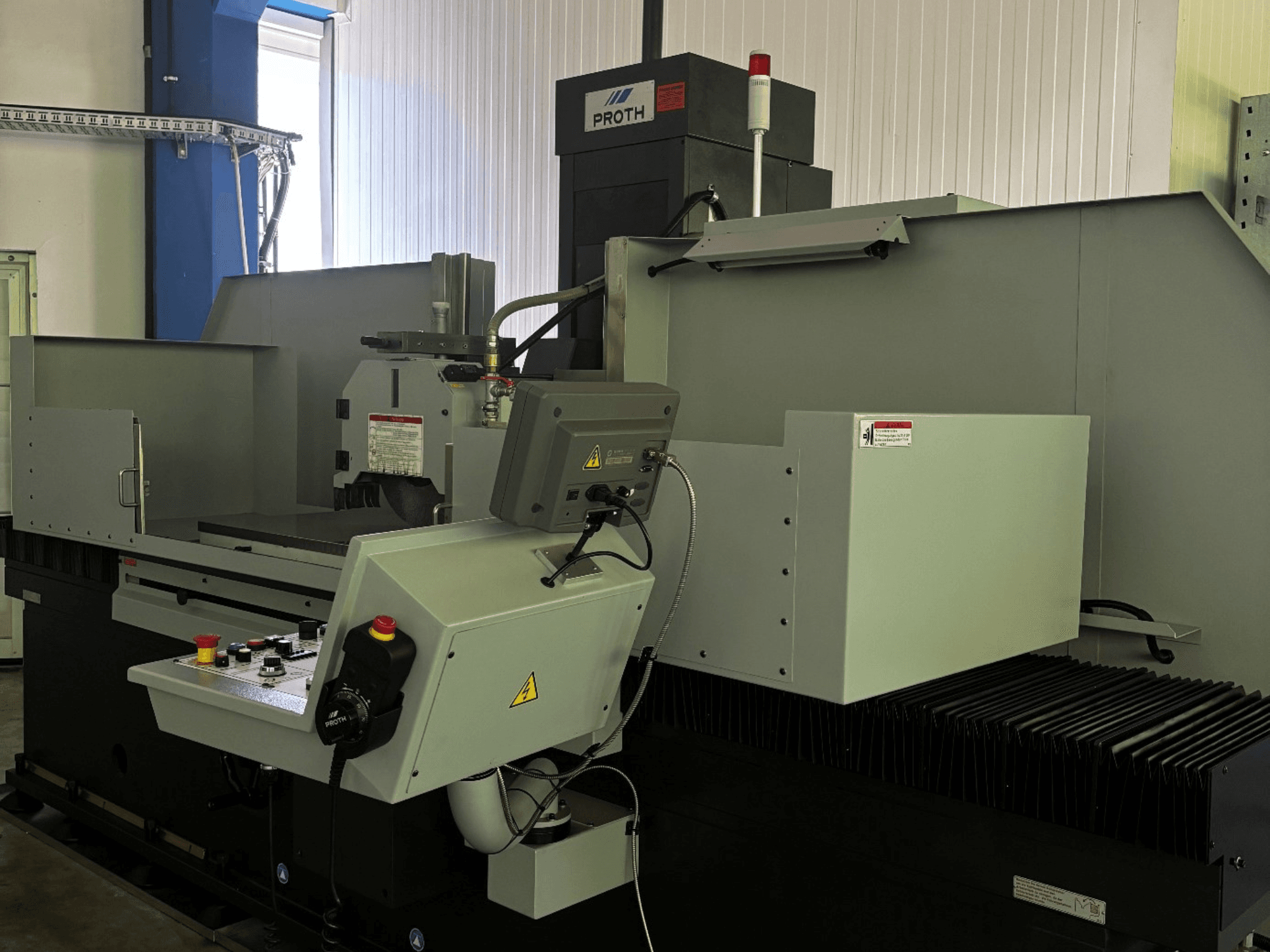 Proth PSGC-50120AHR surface grinding machine, front view, showcasing control panel and grinding wheel area.