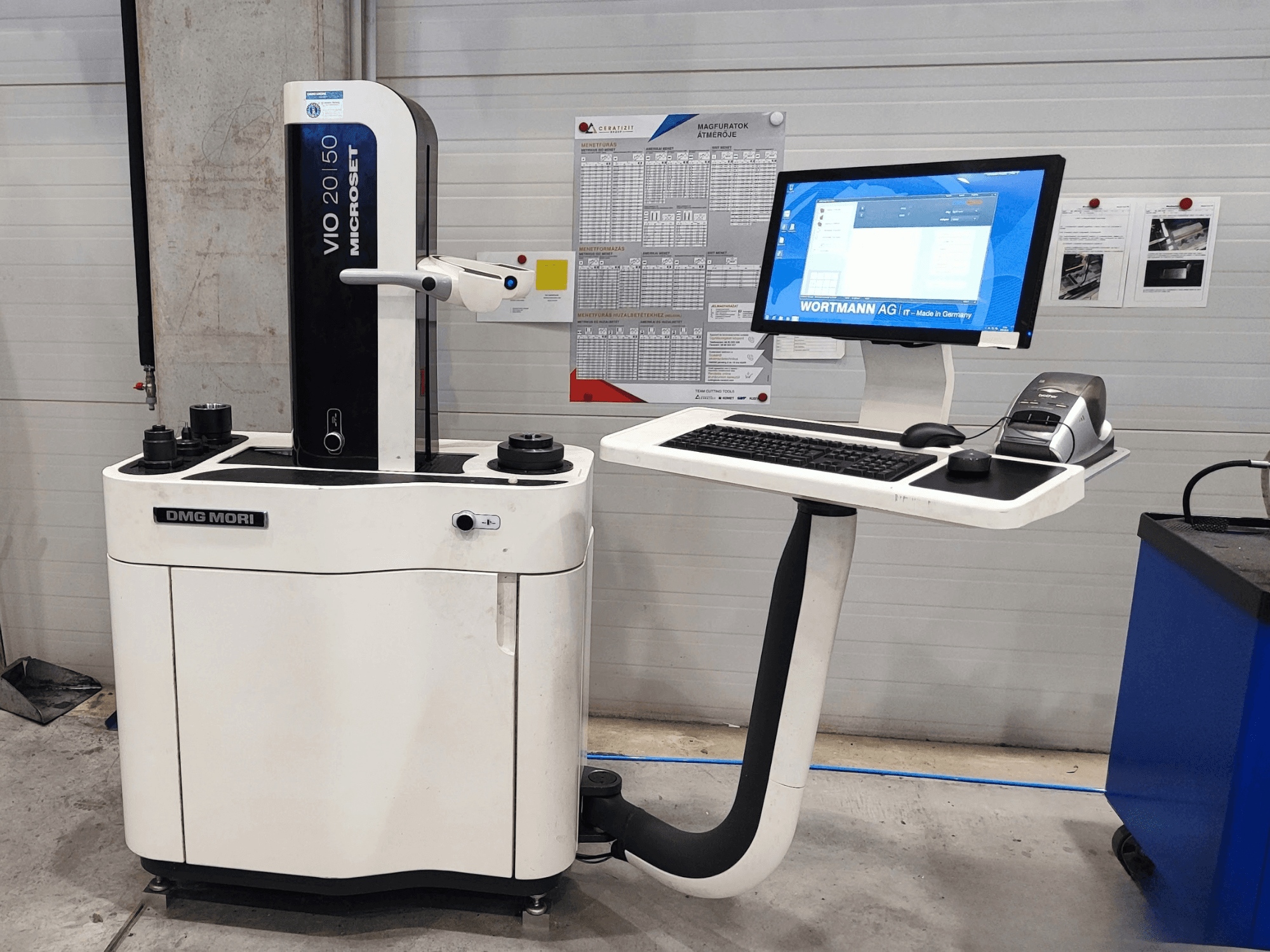 DMG MORI VIO Basic Optical Measurement Machine in front view, featuring a touchscreen monitor, keyboard, and measurement sensors.