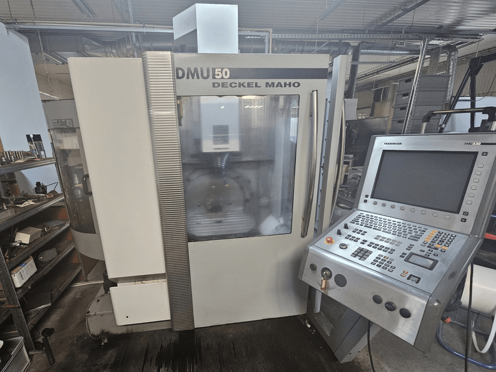 DMU 50 Deckel Maho CNC machine, front view with control panel and operating keys visible, in a workshop setting.