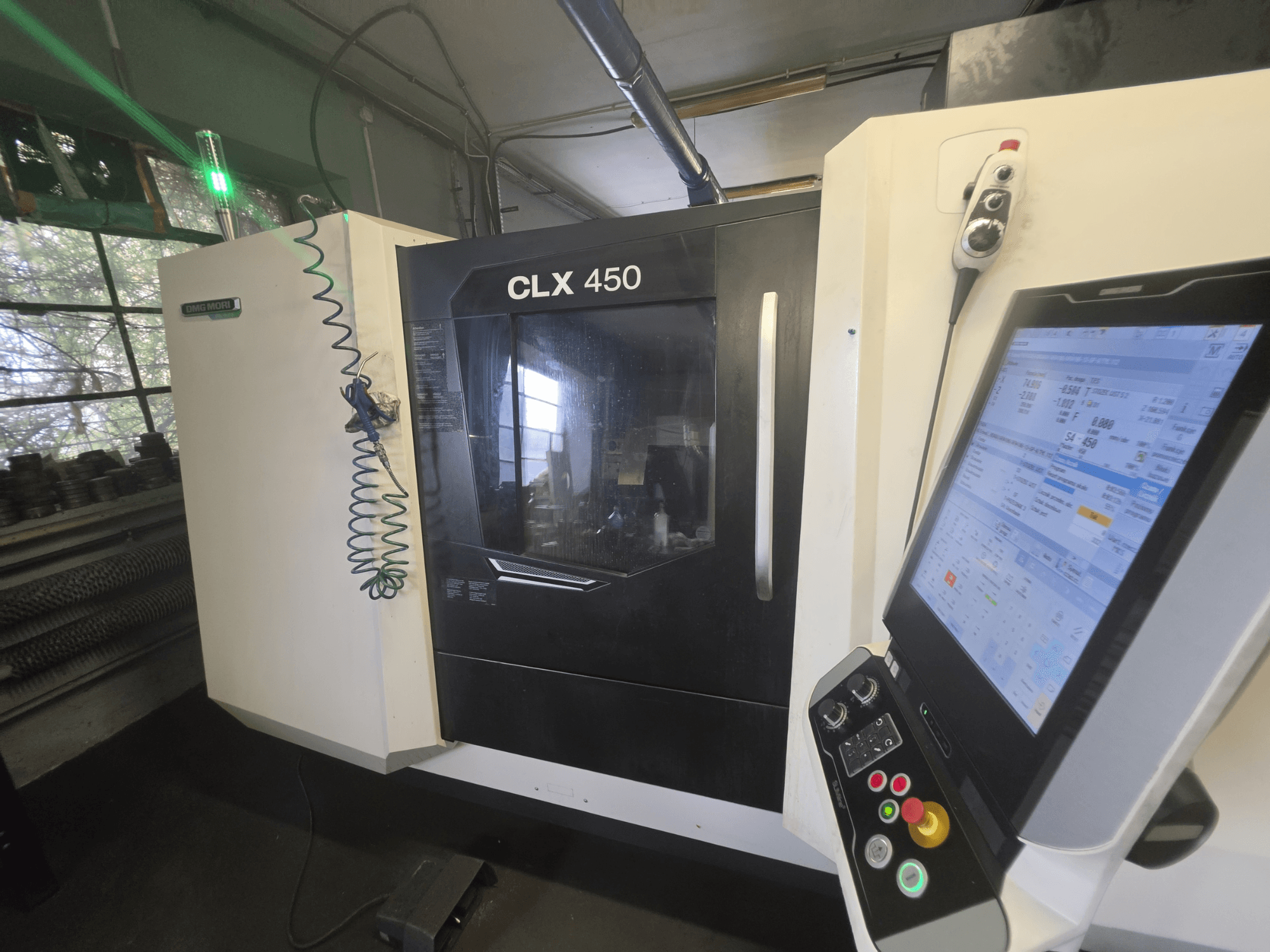 DMG MORI CLX 450 V3 horizontal turning machine, front view with control panel and monitor displaying operational data.