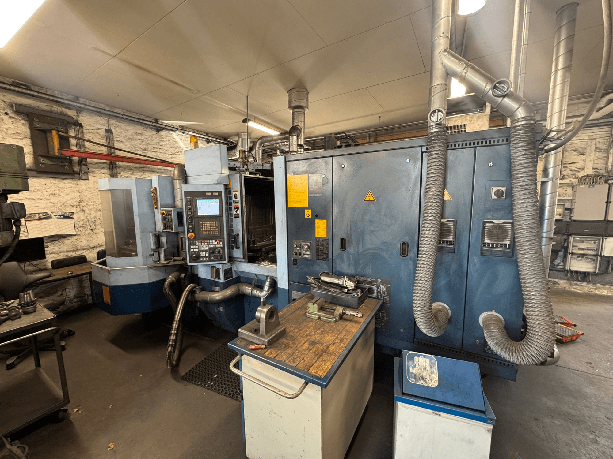 Matsuura H.PLUS-300 horizontal machining centre in a workshop, front view, showing control panel and worktable.