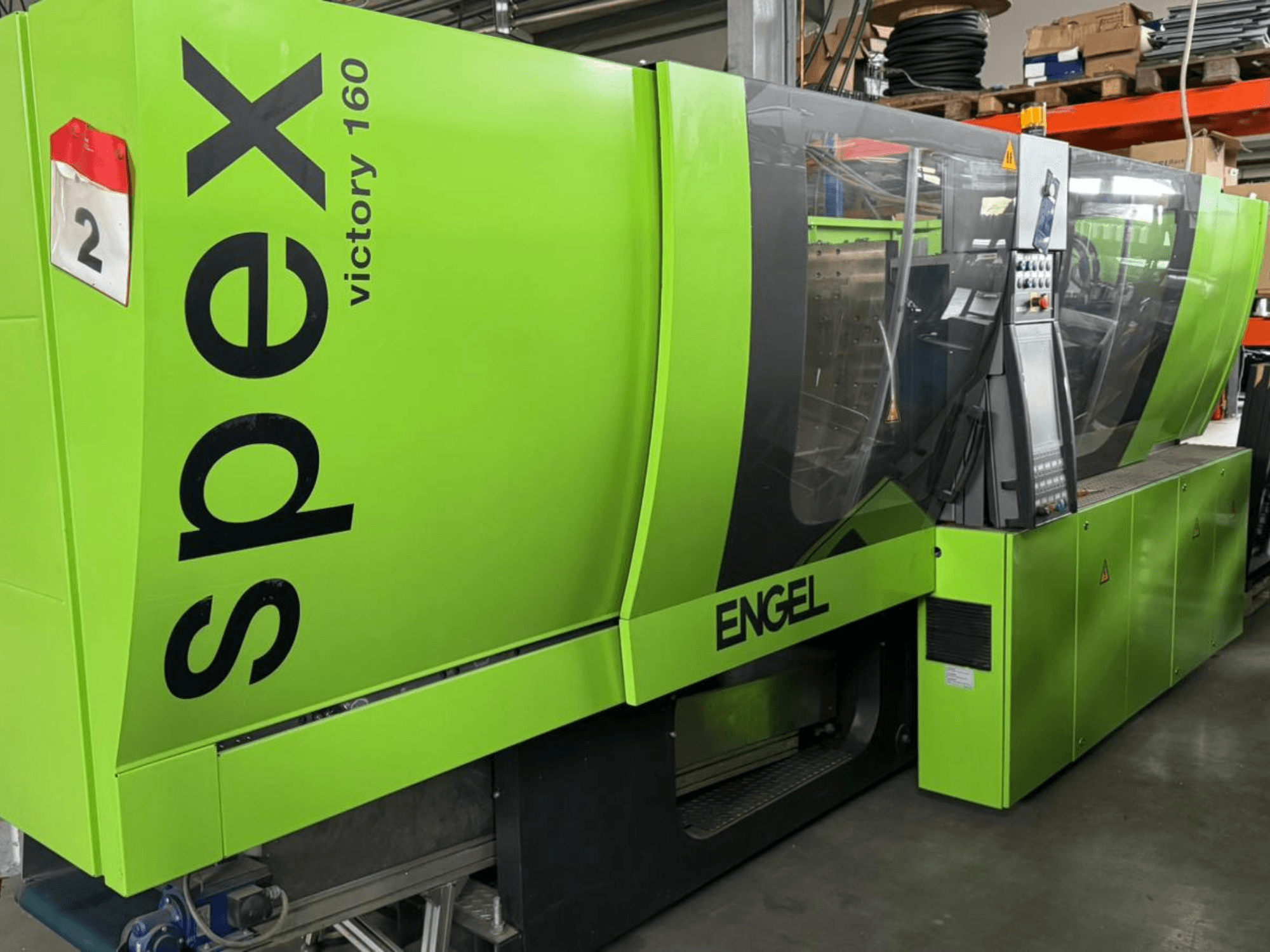 Green Engel Victory 160 machine, front view, with control panel and safety warnings visible, showcasing industrial design.