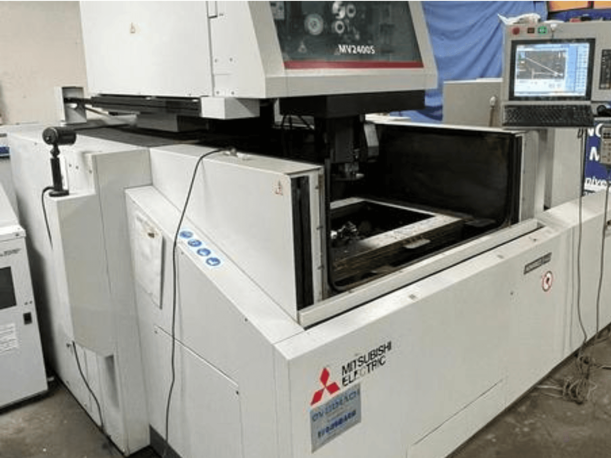 Mitsubishi Electric MV2400S wire cut EDM machine, front view, showing control panel and open work area.