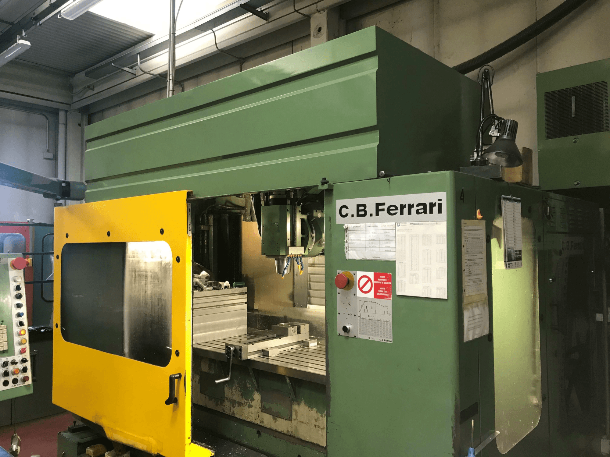 C.B. Ferrari B16 Vertical Machining Centre, front view with yellow safety door, control panel, and machining area visible.