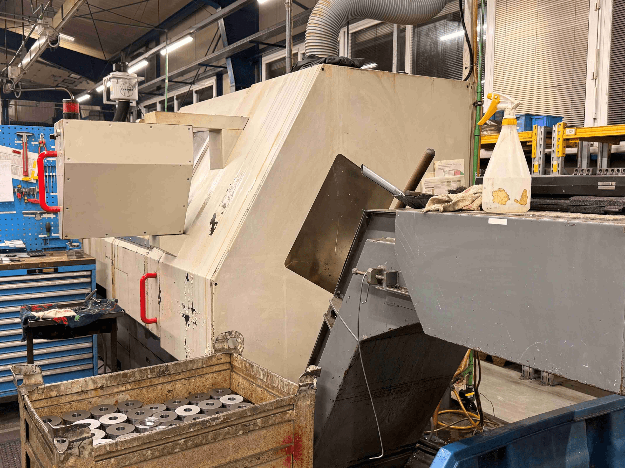 ZPS S-60 CNC horizontal turning machine in workshop, featuring a side view with visible workpieces and controls.