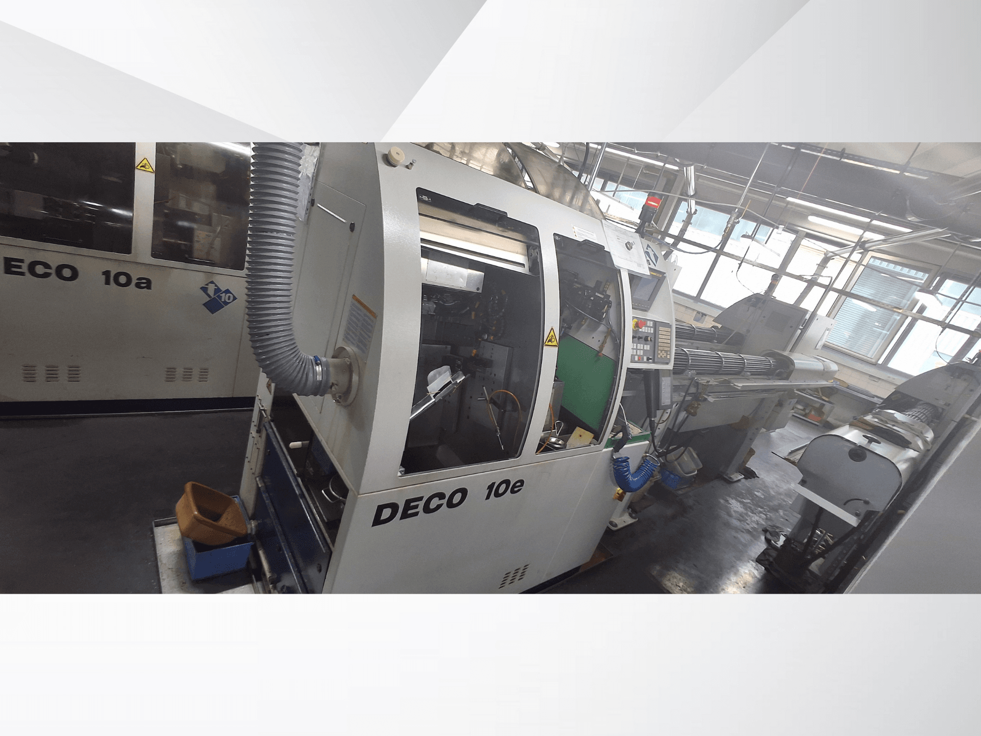 DECO 10e CNC machine in side view, featuring a control panel, green interior, and connected exhaust hose.