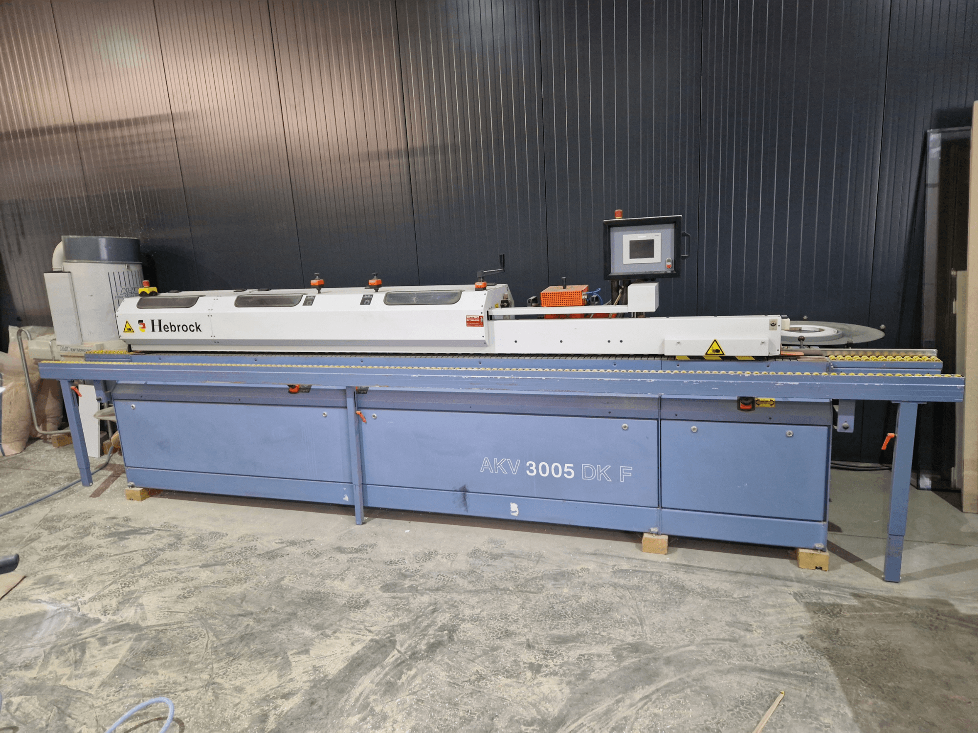 HEBROCK AKV 3005 DK-F edgebander, front view, featuring control panel, feeding belt, and adjustable settings.