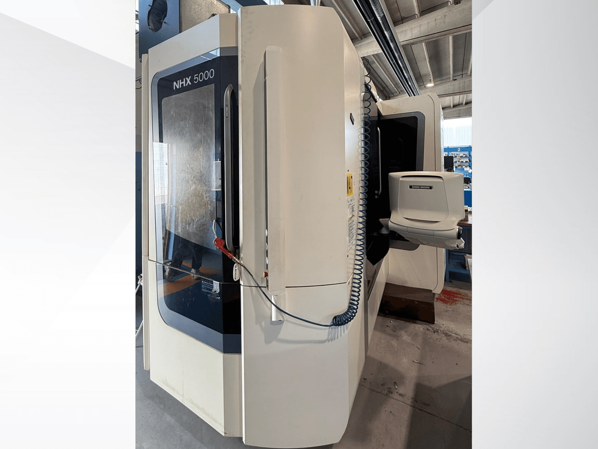 DMG MORI NHX 5000 horizontal turning machine, front view, showcasing control panel and spindle holder.