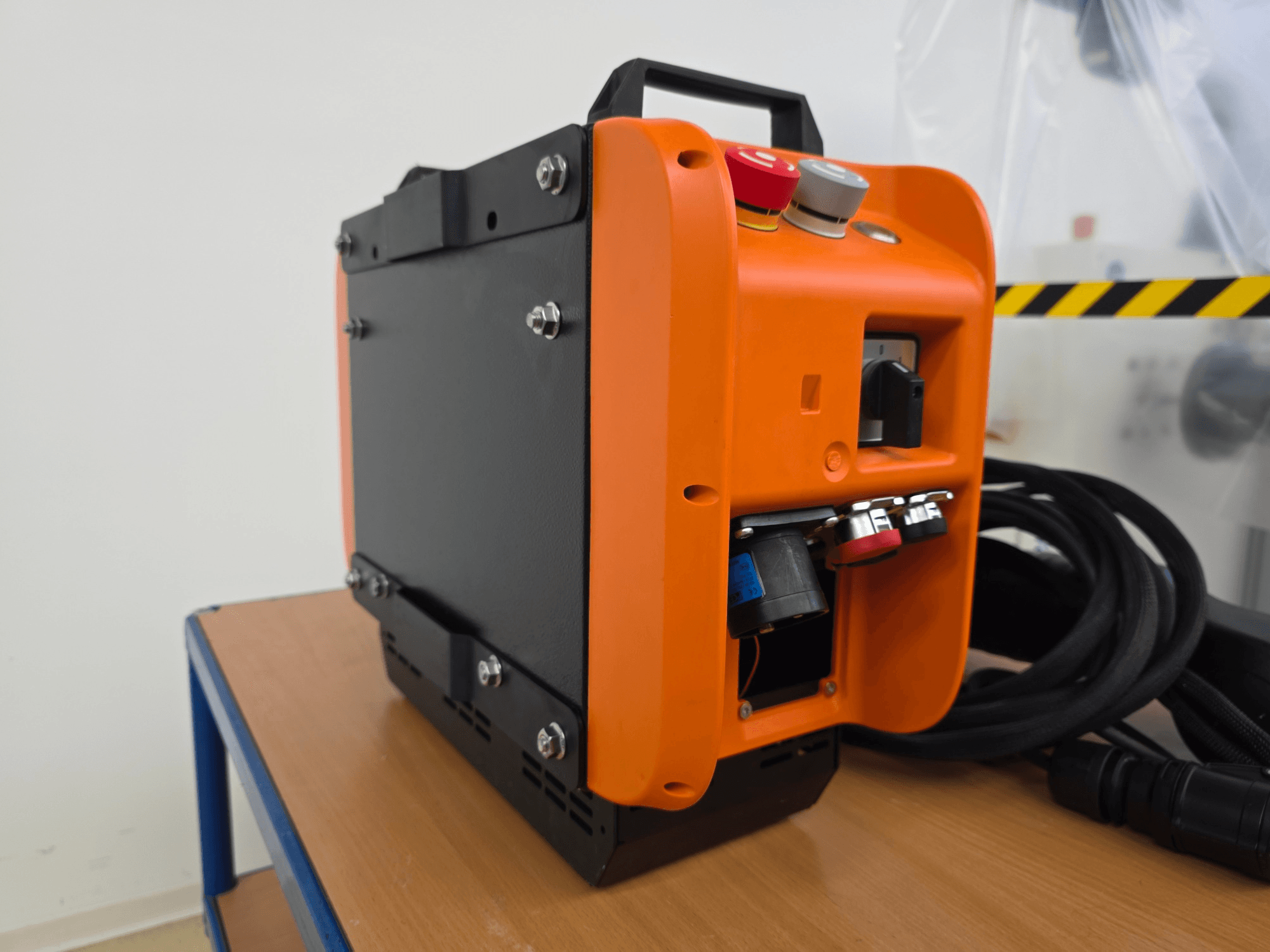 KASSOW ROBOTS KR1205 robot arm controller, side view showing orange and black design, input/output ports, and cables.