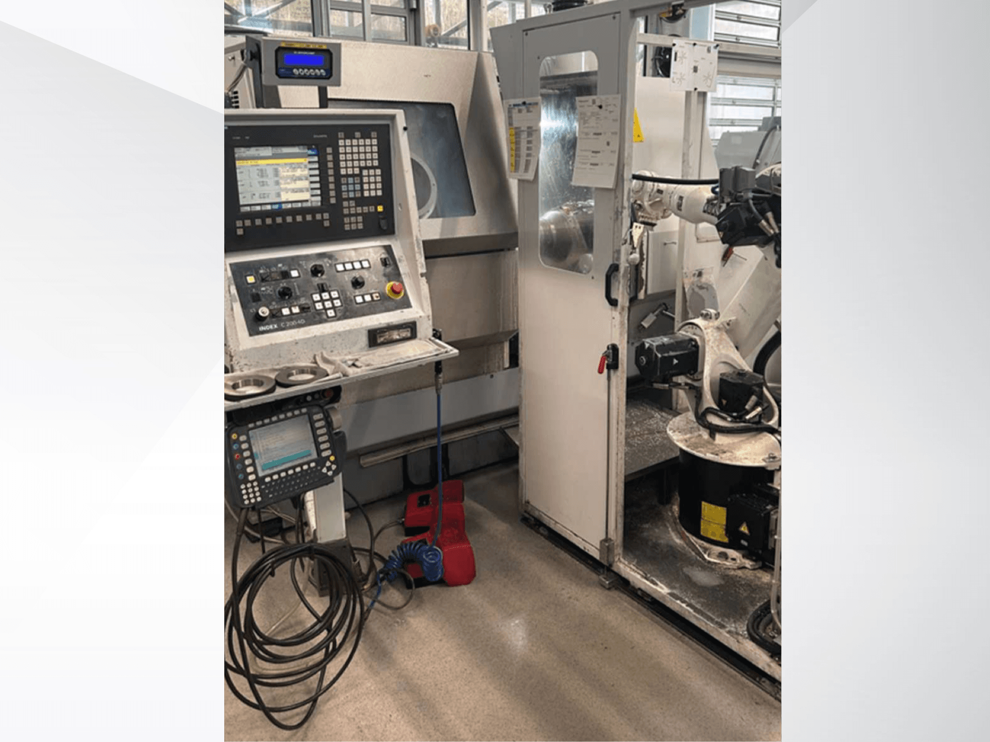 Front view of Index G 200 RATIO LINE turn-mill centre, featuring control panel, robotic arm, and operational workspace.