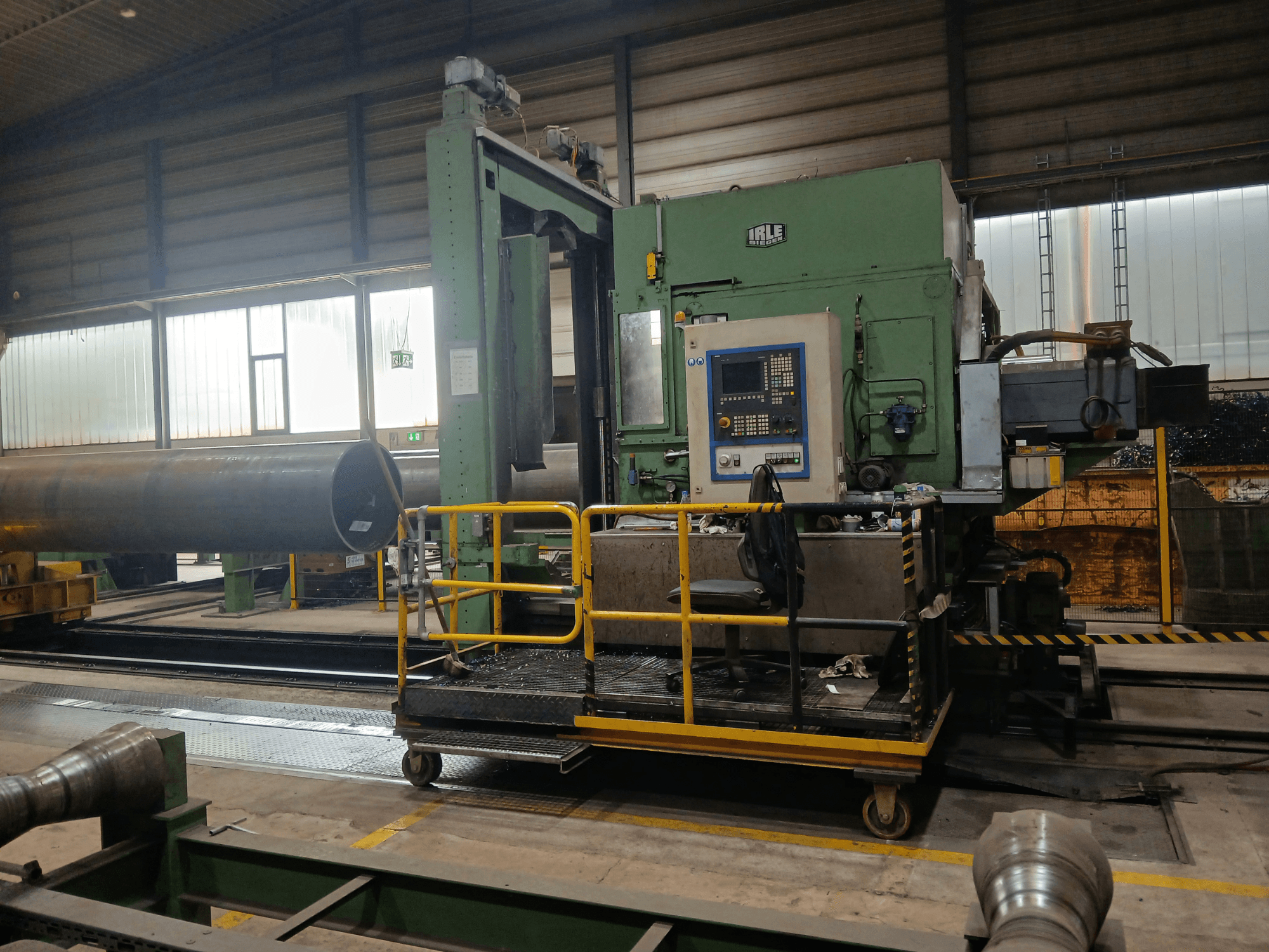IRLE IRD 1600 CNC horizontal machining center viewed from the side, highlighting control panel and rail system for heavy workpieces.