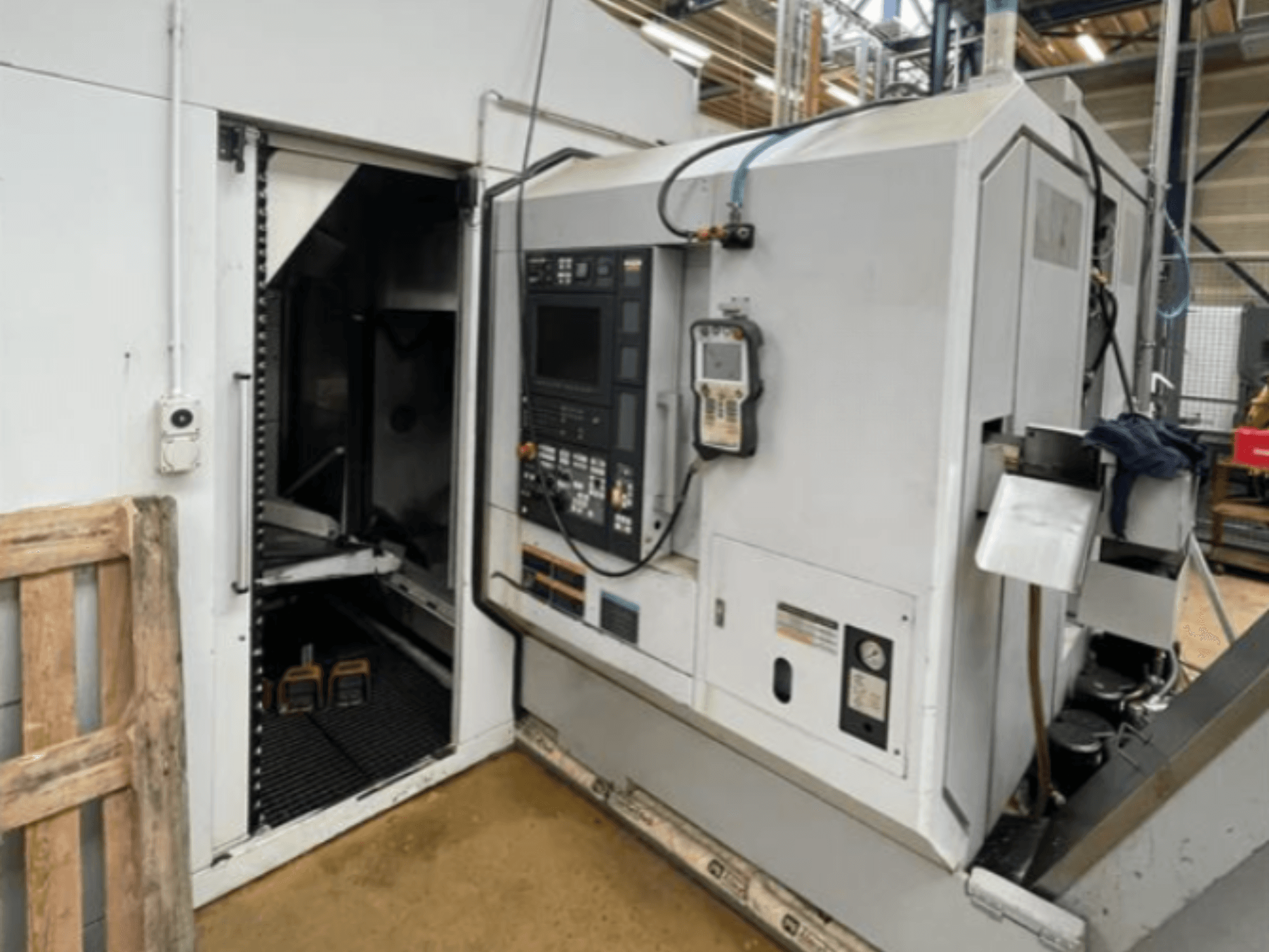 DMG Mori Seiki NZ2000T3Y2 horizontal turning machine, side view showing control panel and machine interior.