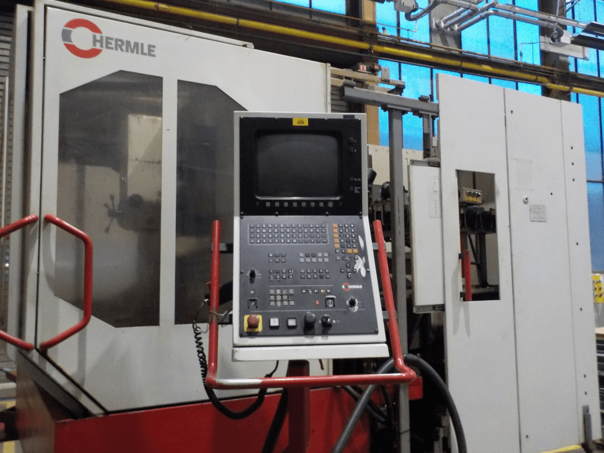 Front view of HERMLE vertical machining center UWF 1002 H, showing control panel with buttons and monitor.