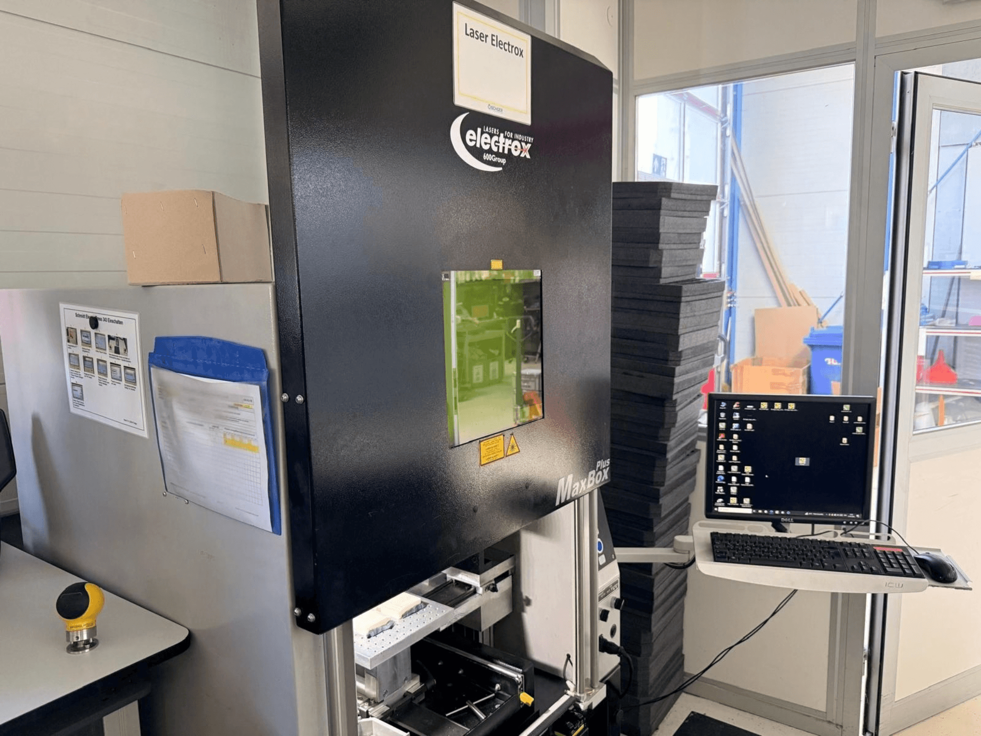 ELECTROX MaxBox Plus laser marking machine in a side view, featuring a control monitor, green-viewing window, and workspace.