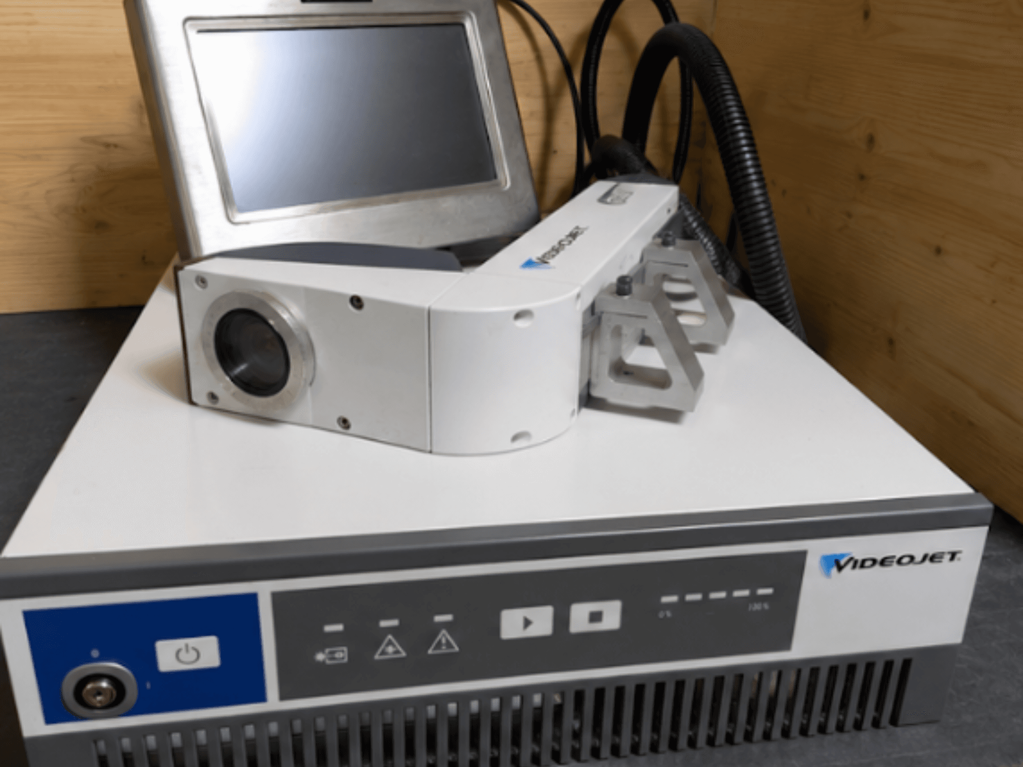 Videojet 7230 Laser Engraving Machine, front view, showing control panel and laser head with lens and attachment.