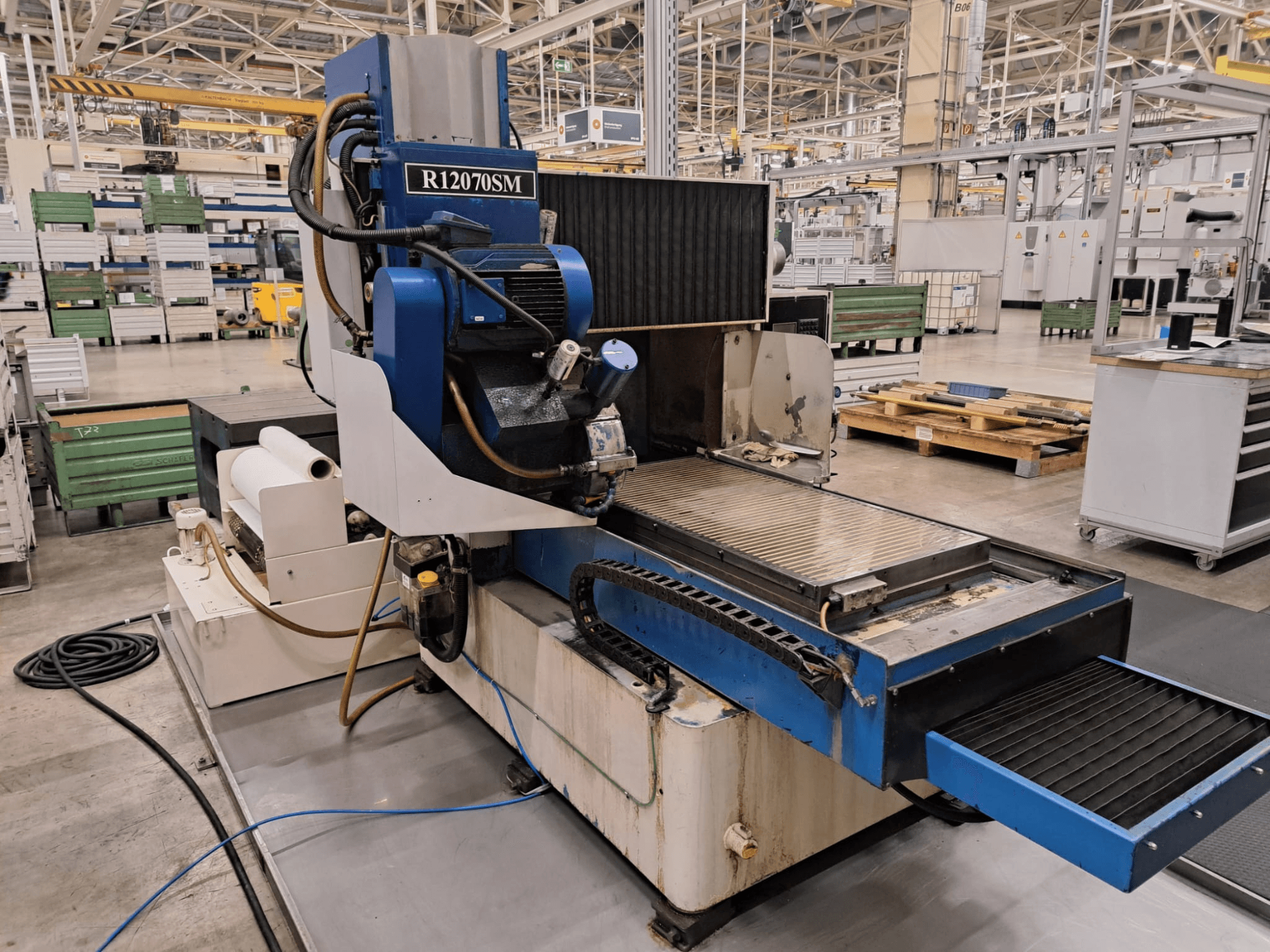 Surface grinding machine LGB R12070SM in a factory setting, viewed from the front, showcasing its operational features and layout.