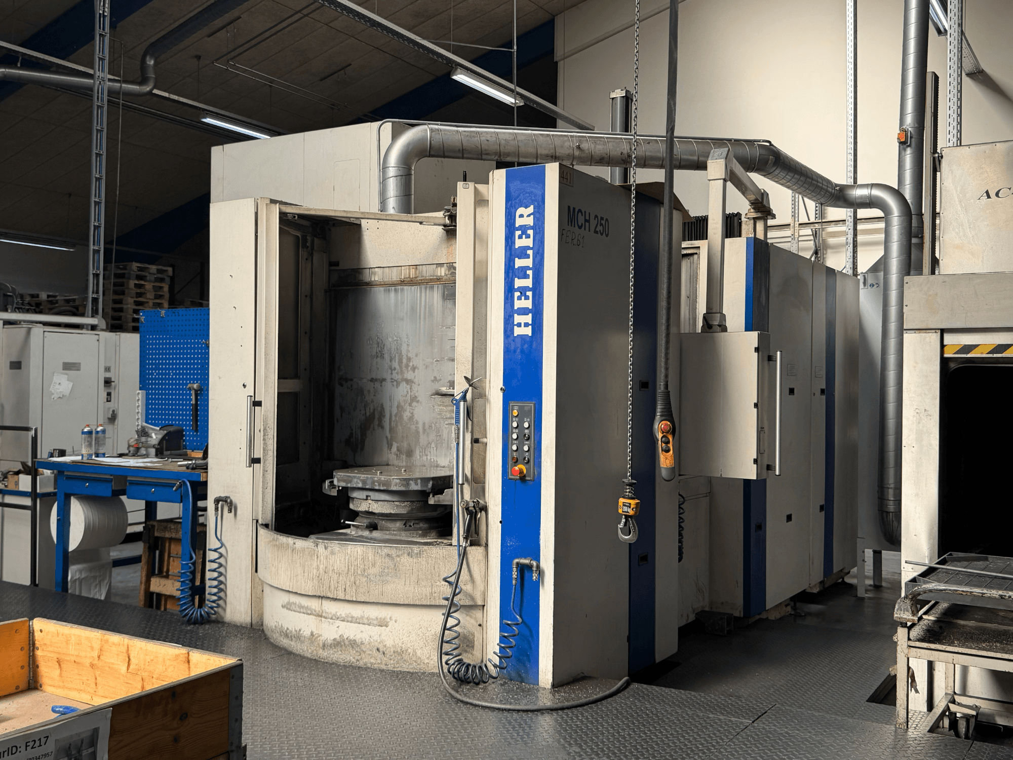 Front view of HELLER MCH 250 horizontal machining centre with control panel, large rotating table, and industrial environment.